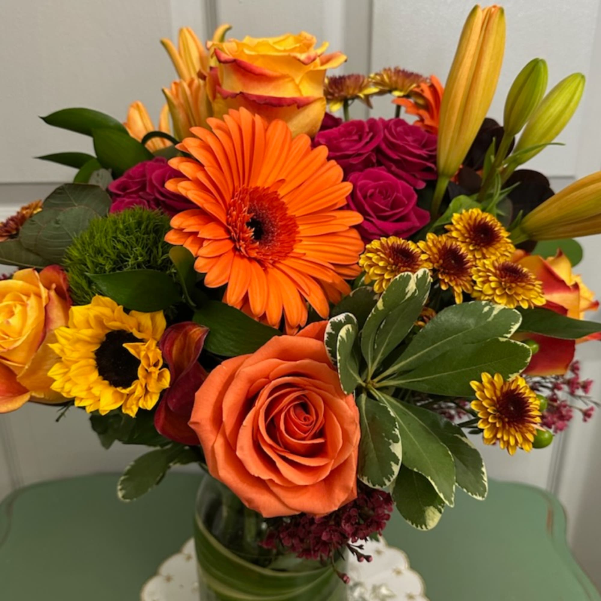 Bouquet of orange and yellow flowers in a glass vase