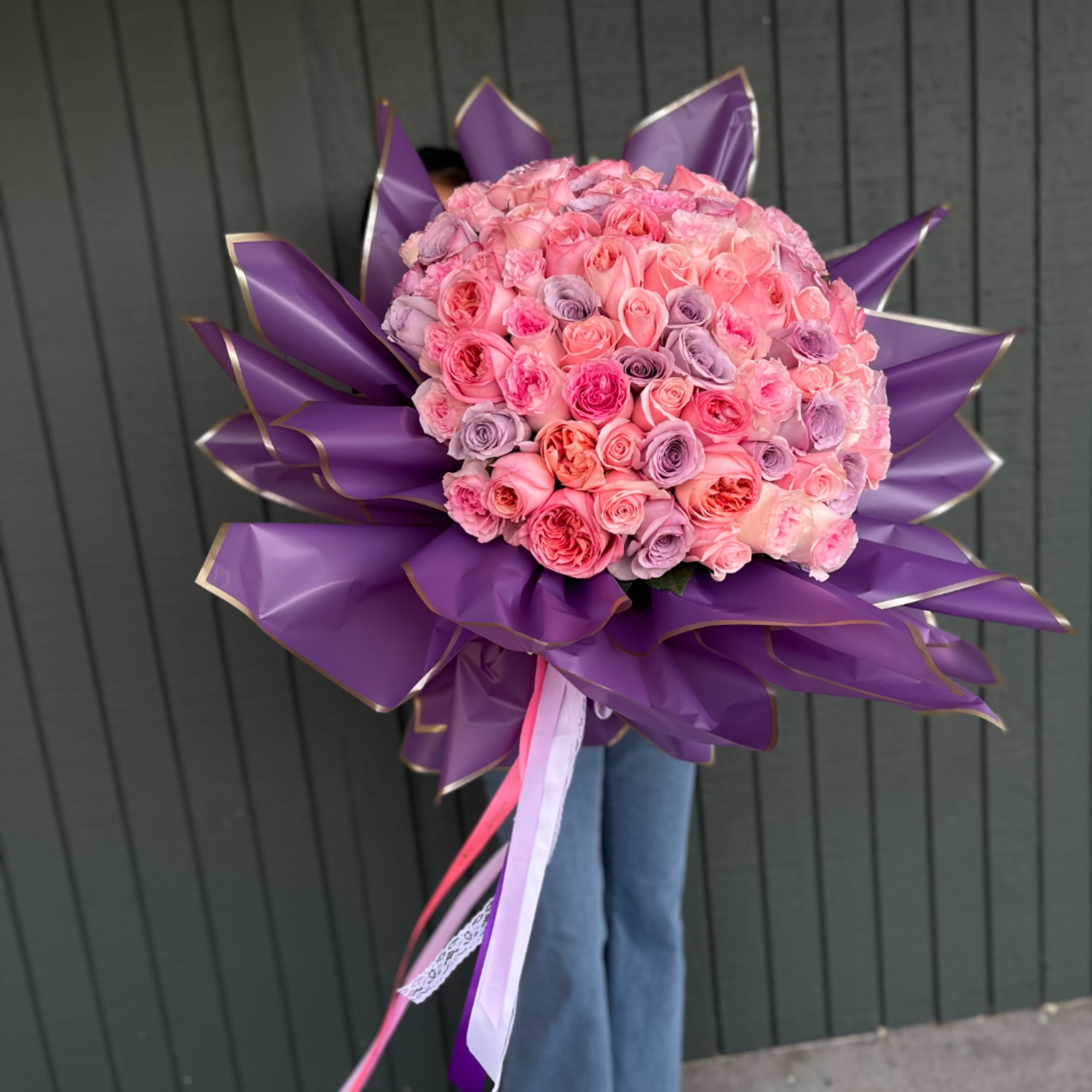 Large bouquet of pink and lavender roses wrapped in purple paper, photo 3 of 3