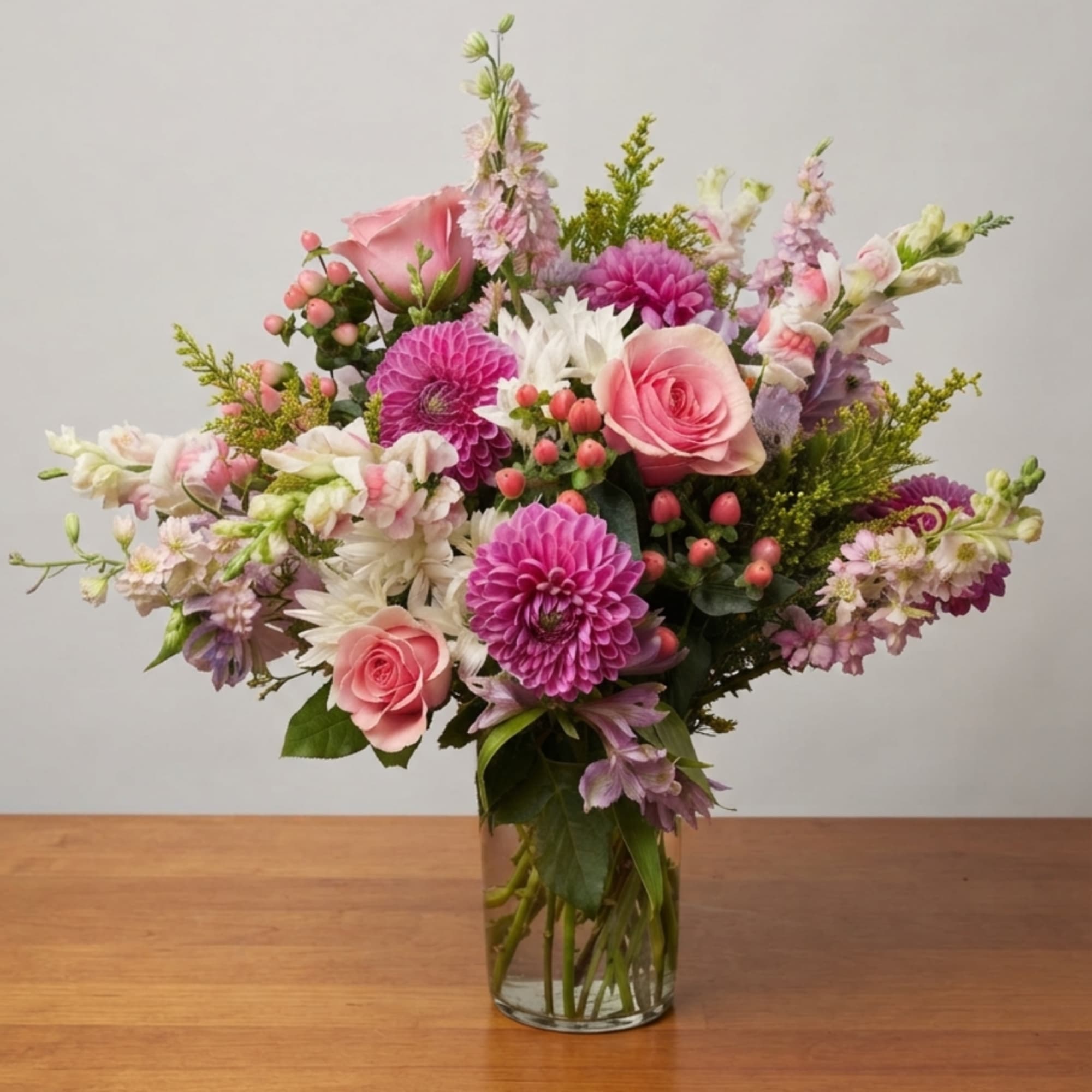 Pink and white mixed flower bouquet in a clear glass vase