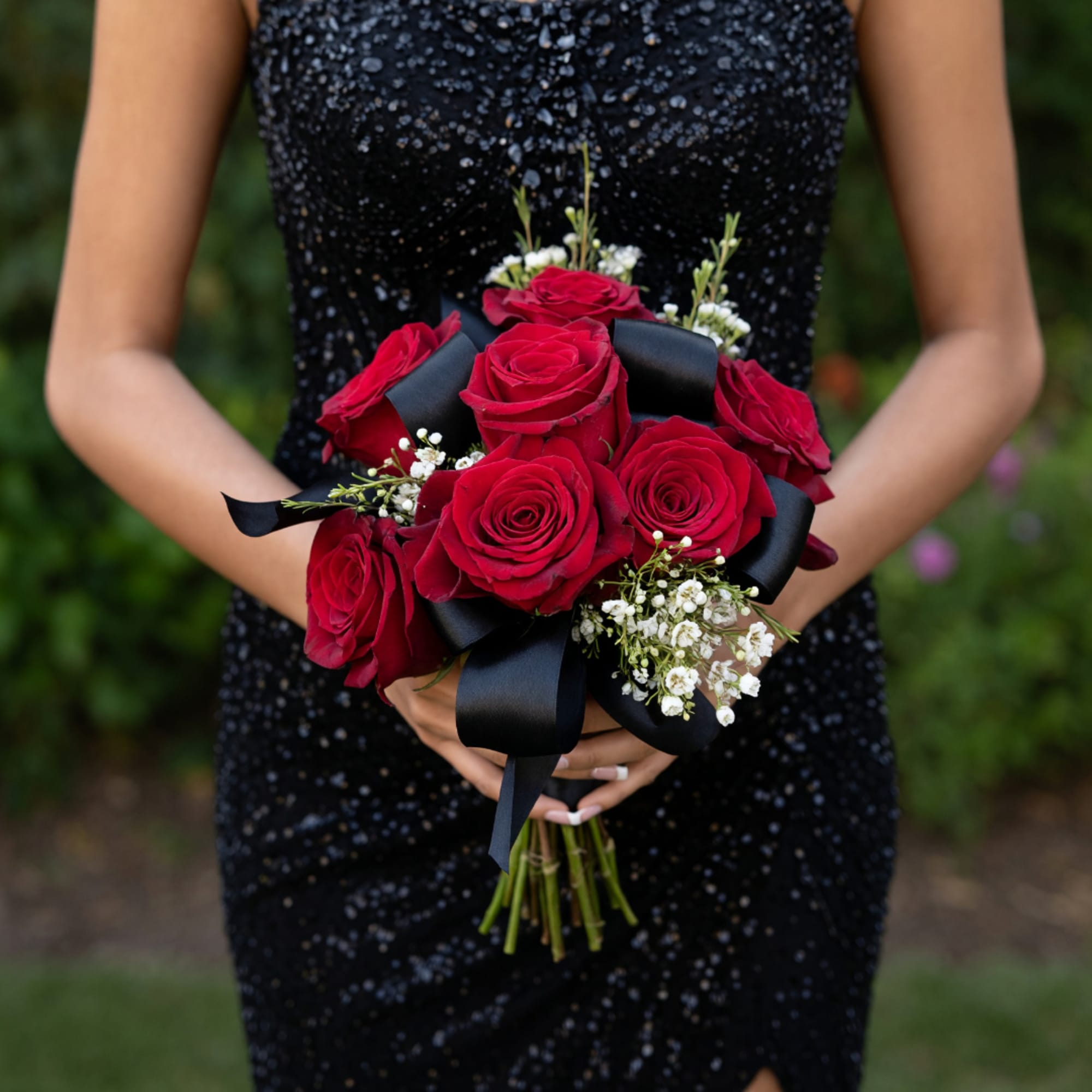 Woman holding a bouquet of red roses with black ribbon, photo 2 of 2