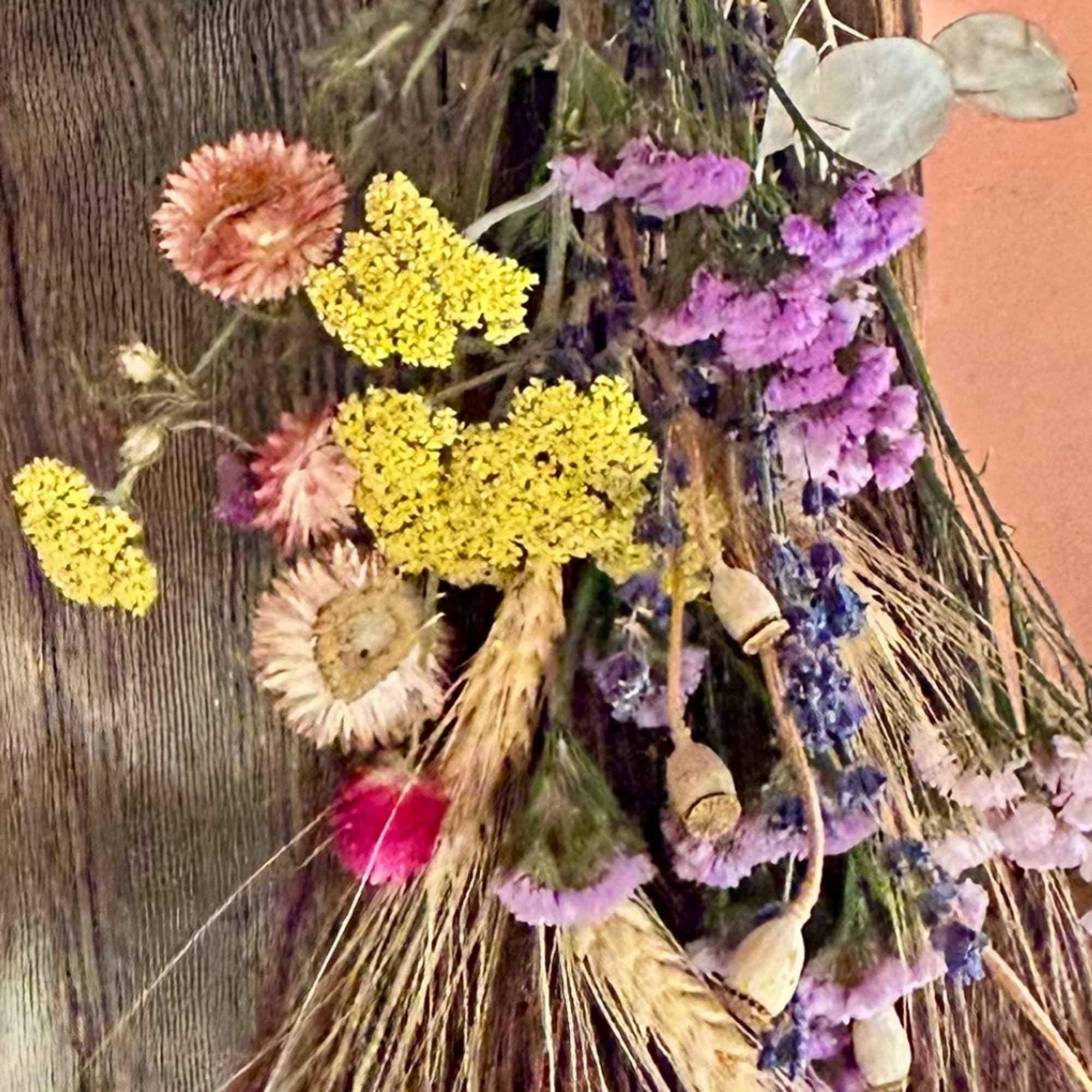 Dried flower arrangement with yellow, purple, and pink blooms