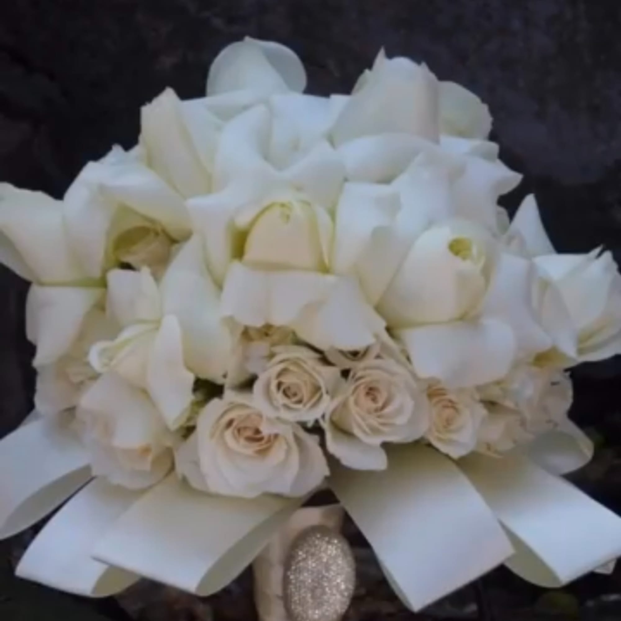 White rose and calla lily bouquet with a wide white ribbon
