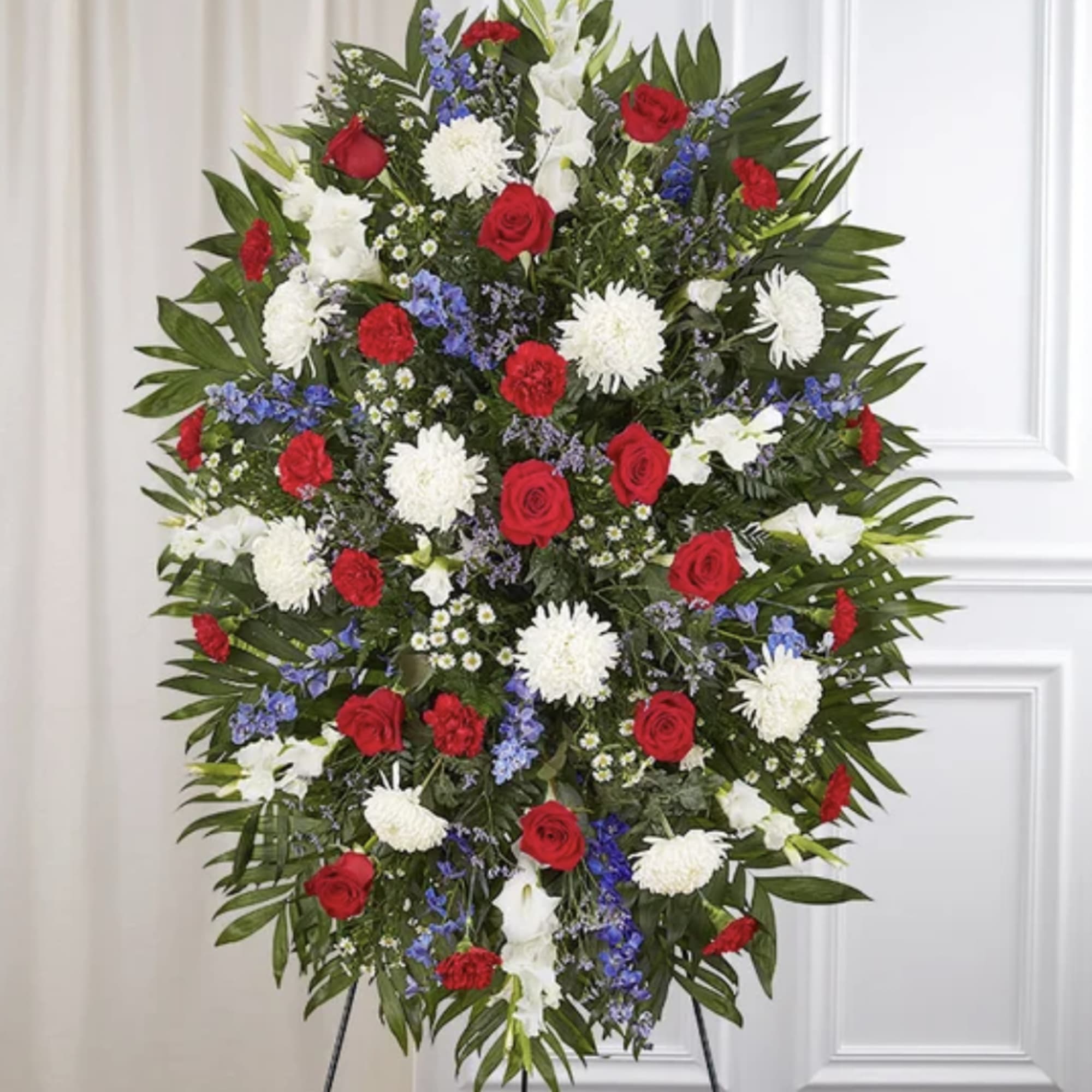 A striking red, white, and blue standing spray designed to honor a
