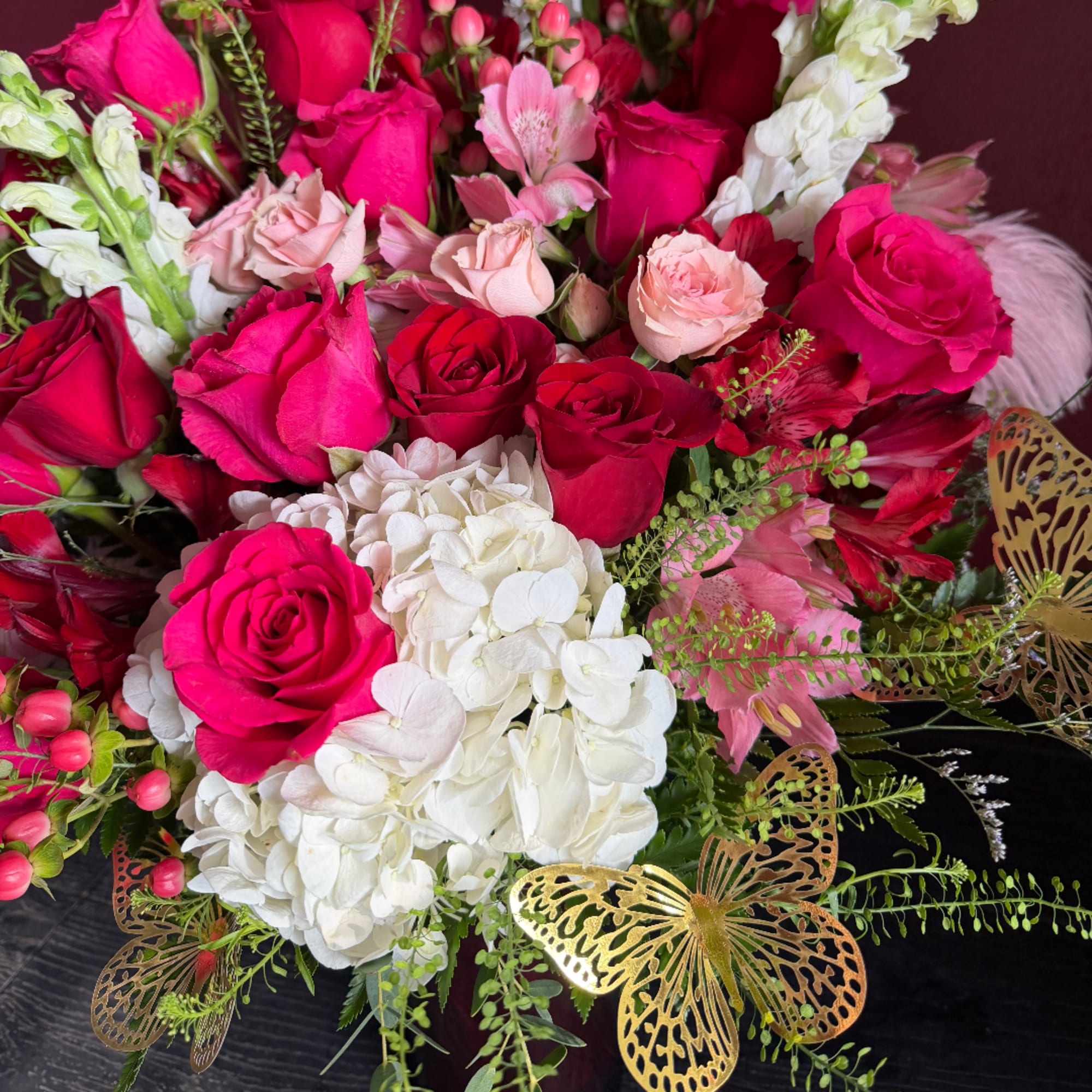 Bouquet of pink and white roses with hydrangeas and butterfly decorations