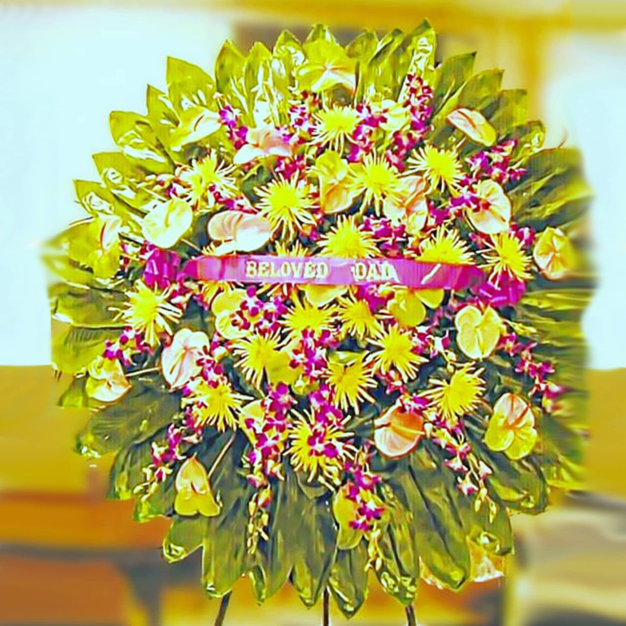 Large round standing wreath of yellow and pink flowers with a Beloved Dad ribbon.