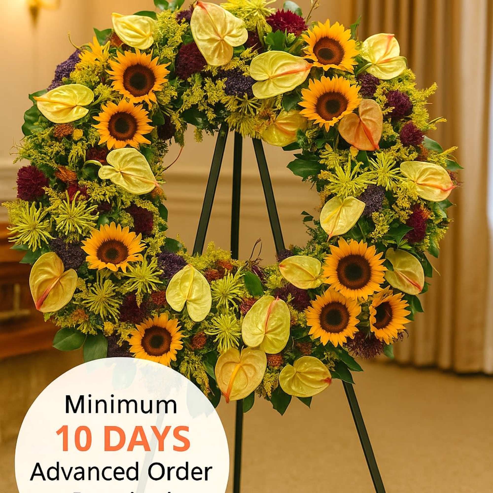 Large standing wreath of sunflowers and mixed yellow blooms on a black easel