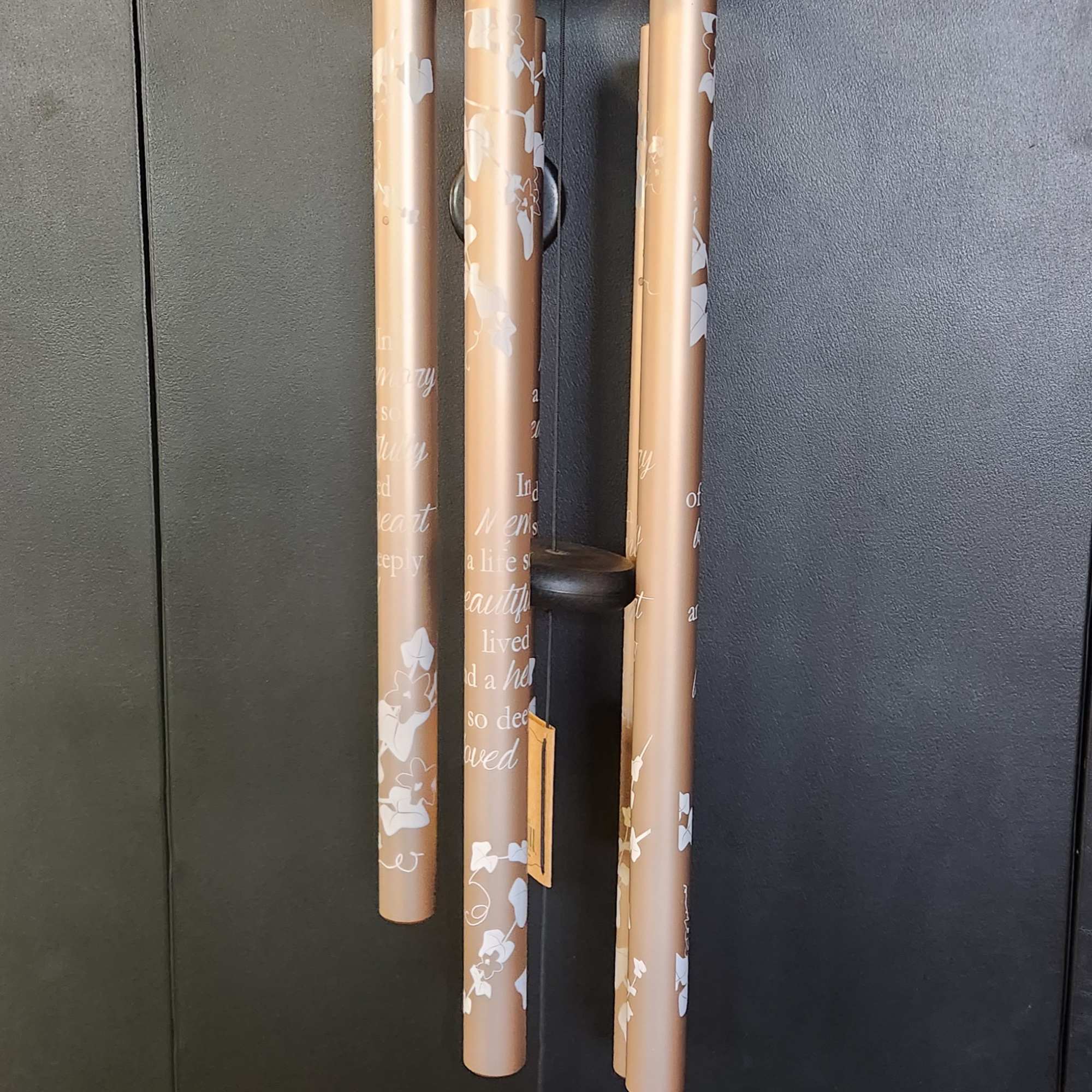 Memorial wind chime with tan tubes and a hanging plaque