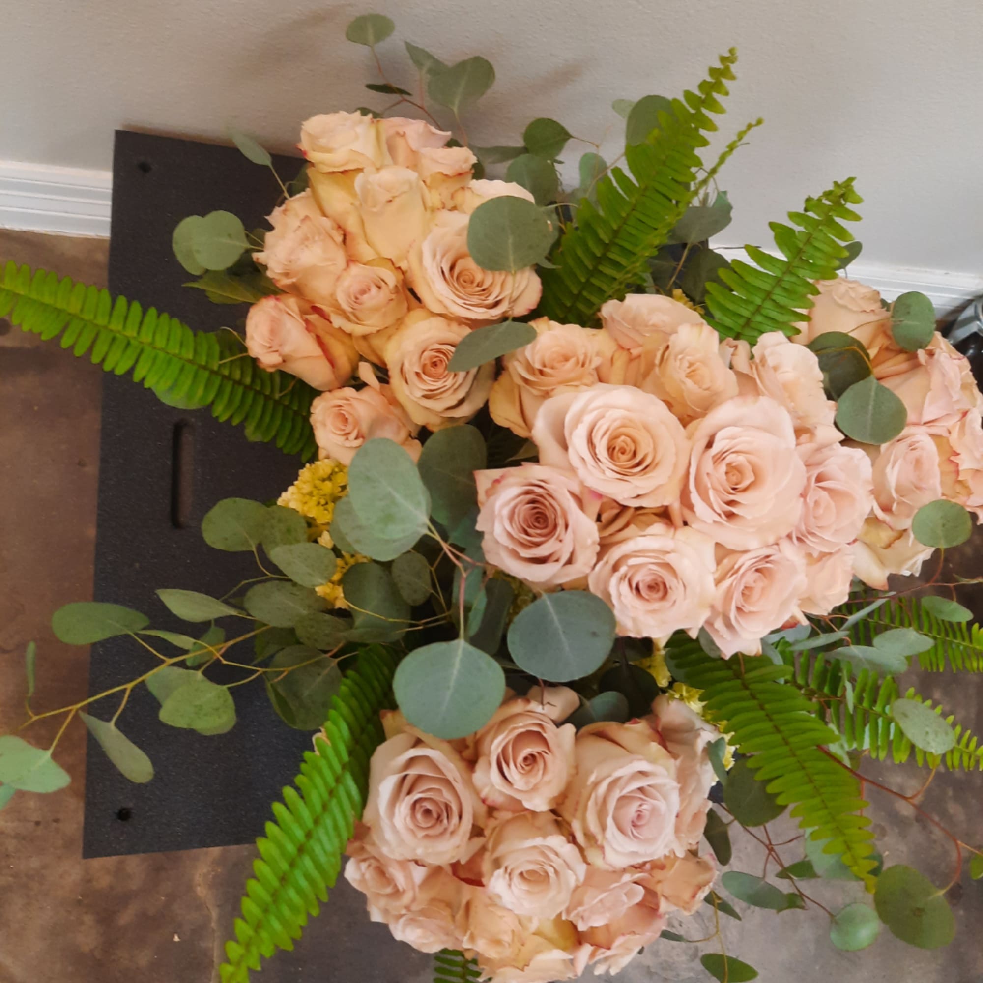 Bouquet of pale peach roses with eucalyptus and fern fronds