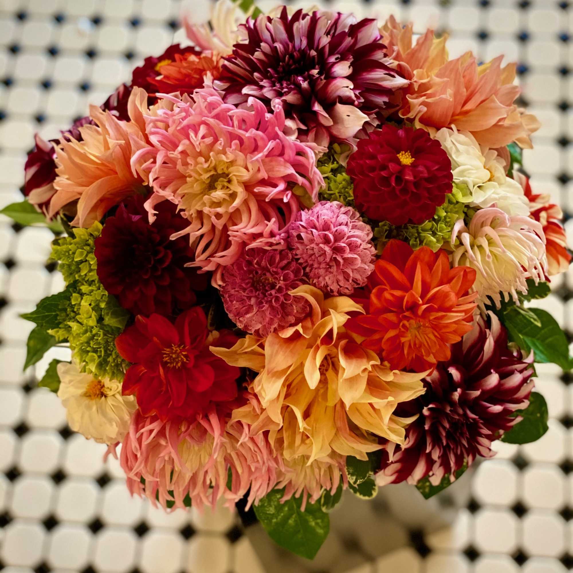 Mixed bouquet of colorful dahlias in pink, red, orange, and cream