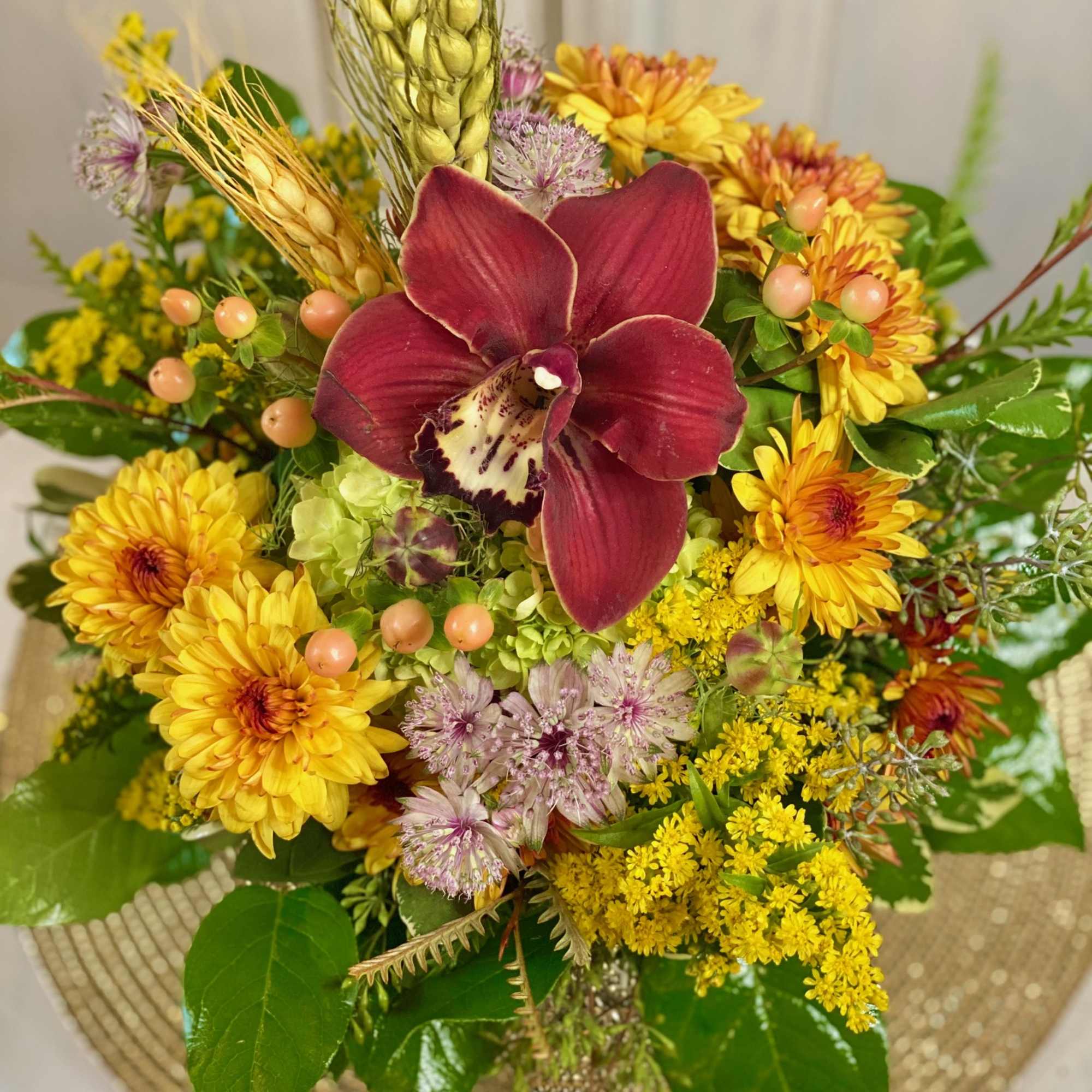Mixed bouquet with a burgundy orchid and yellow chrysanthemums