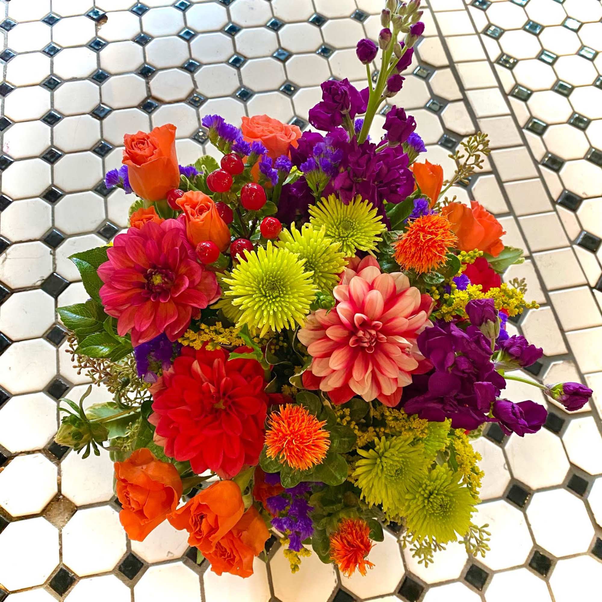 Bright mixed bouquet with roses, dahlias, and purple blooms