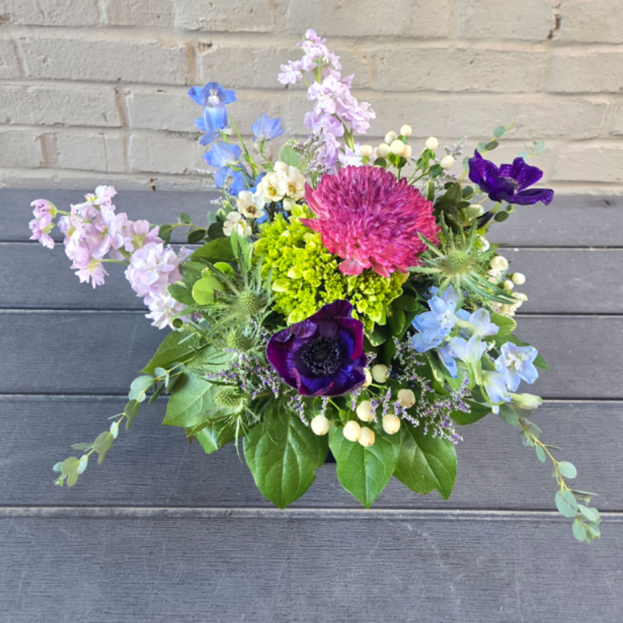 Colorful mixed bouquet with purple, blue, pink, and green flowers