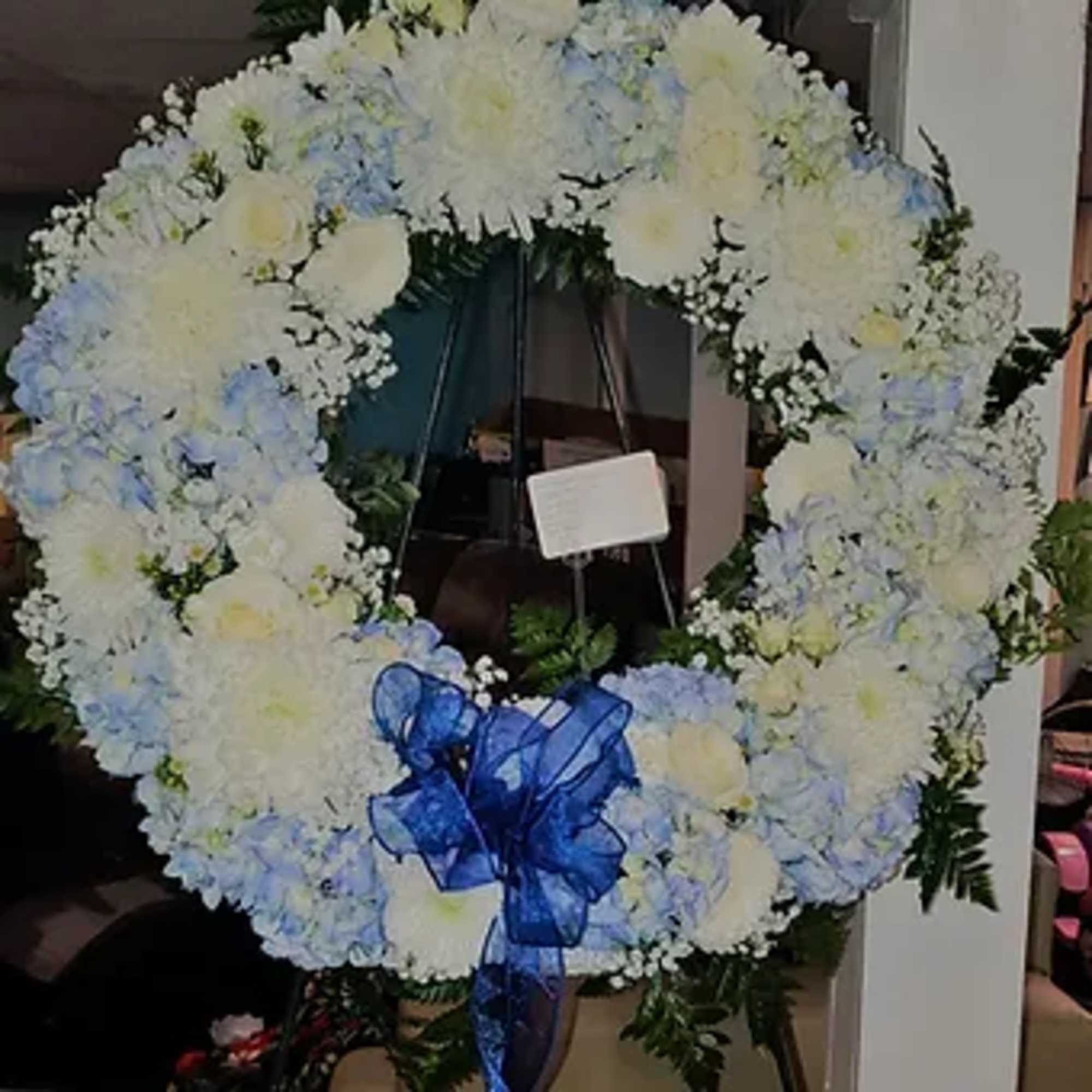 22 inch round wreath with roses, hydrangea, mums and lilies. Can be