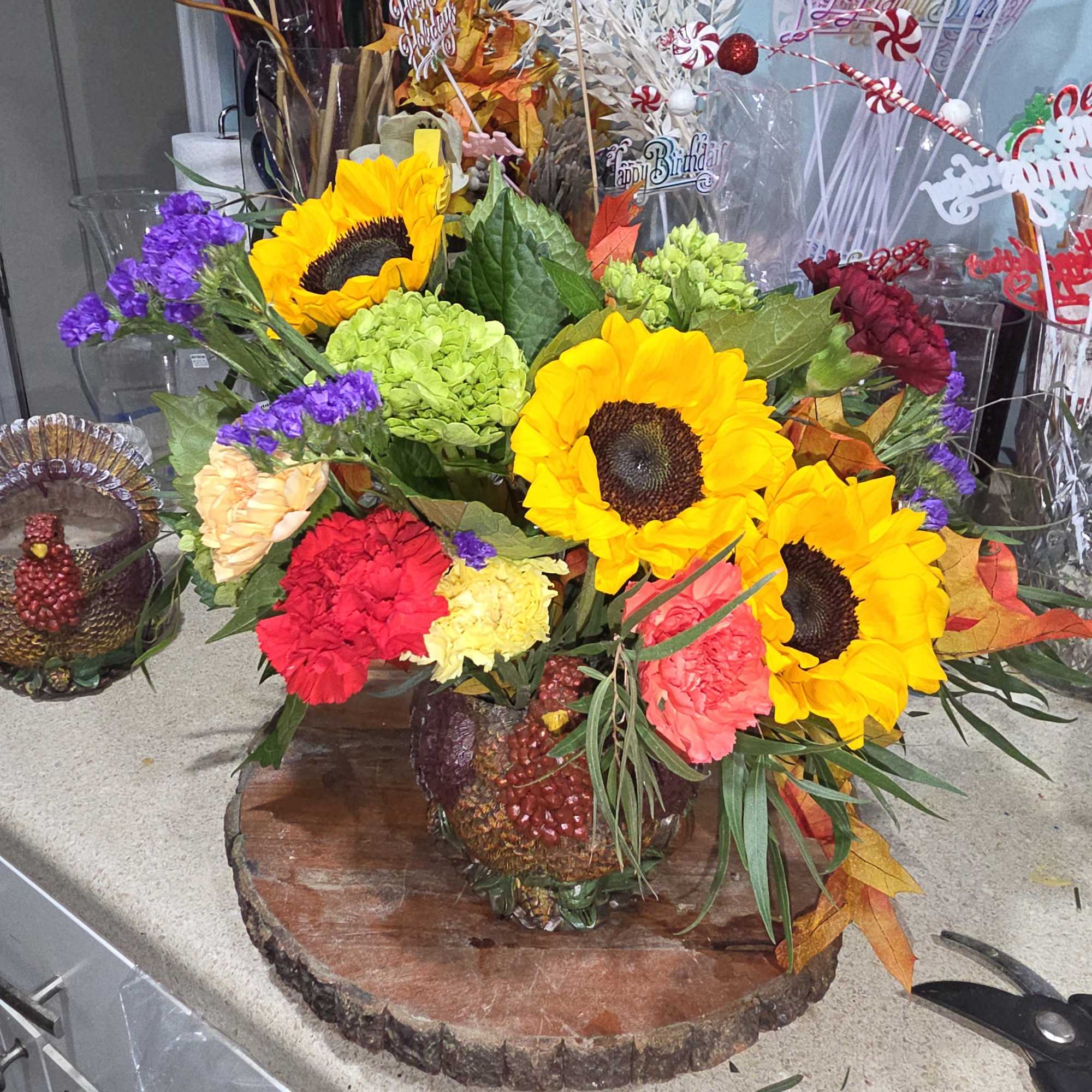 6 inch detailed resin turkey planter, filled with seasonal blooms.  Perfect