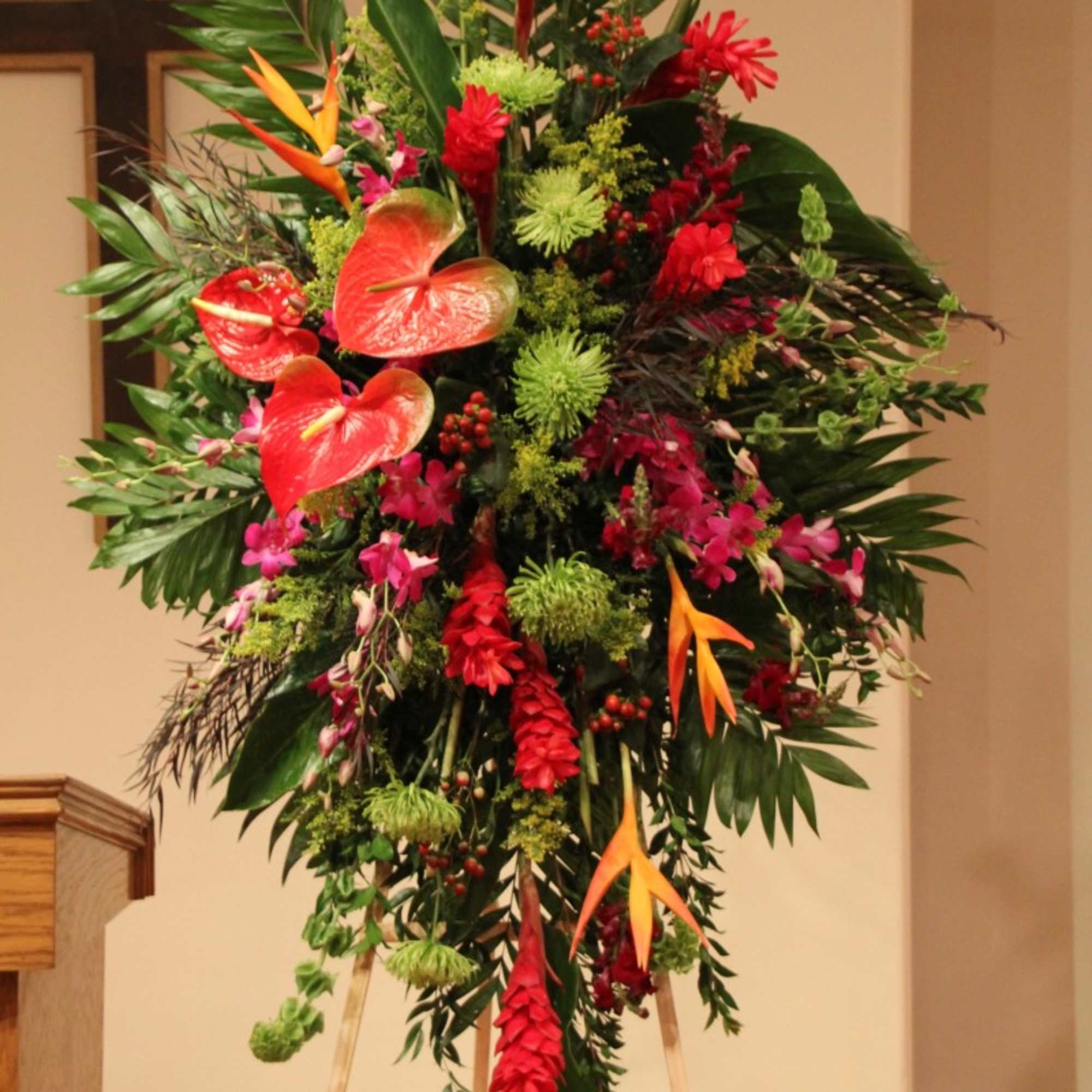 Tall tropical standing floral spray with red and orange blooms