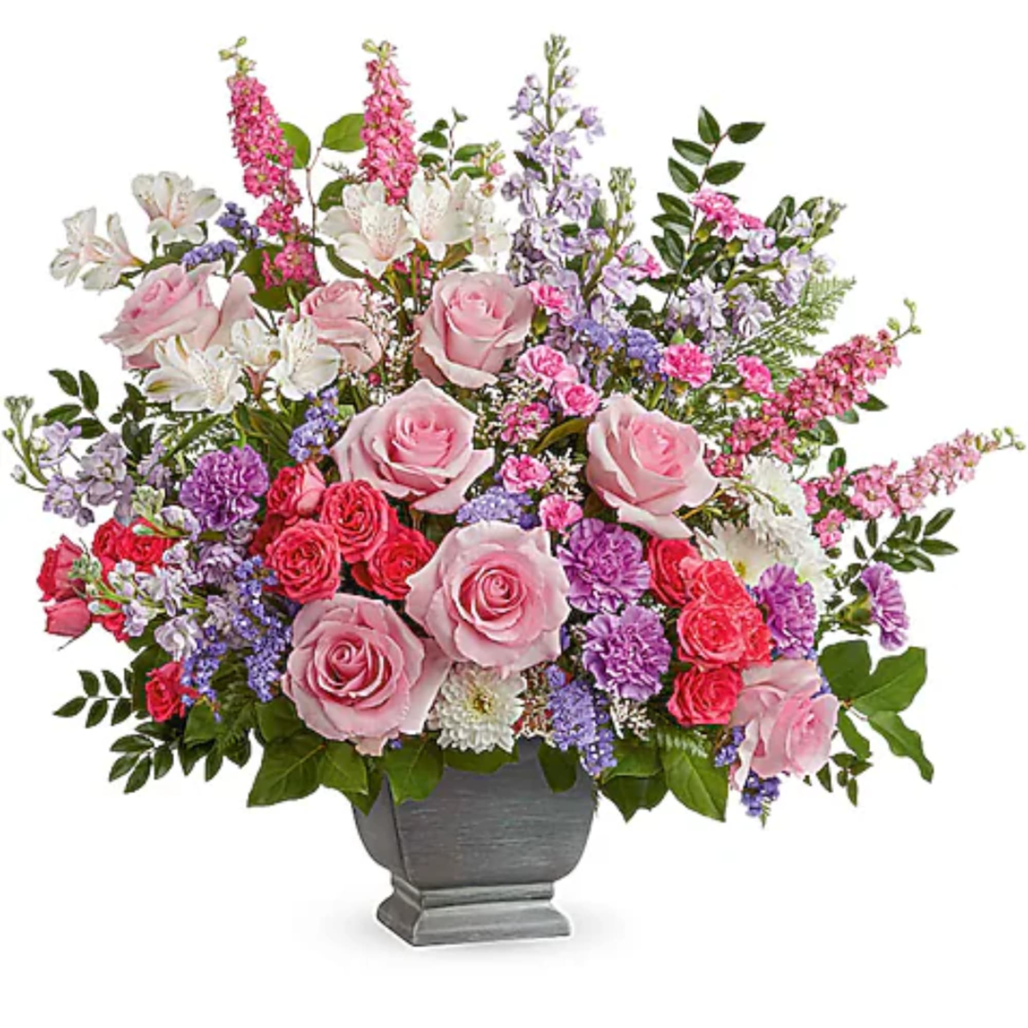 Pink and purple mixed flower arrangement in a gray urn vase