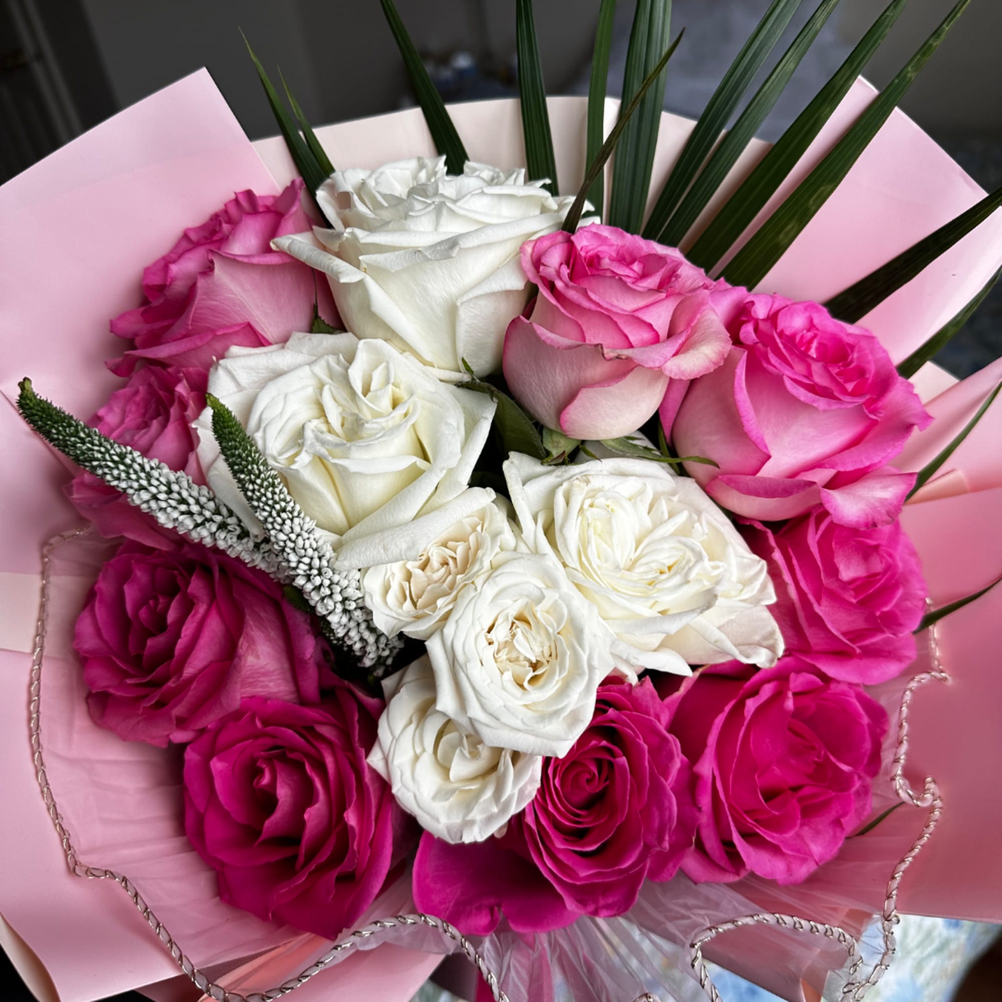 Bouquet of pink and white roses wrapped in pink paper, photo 2 of 3
