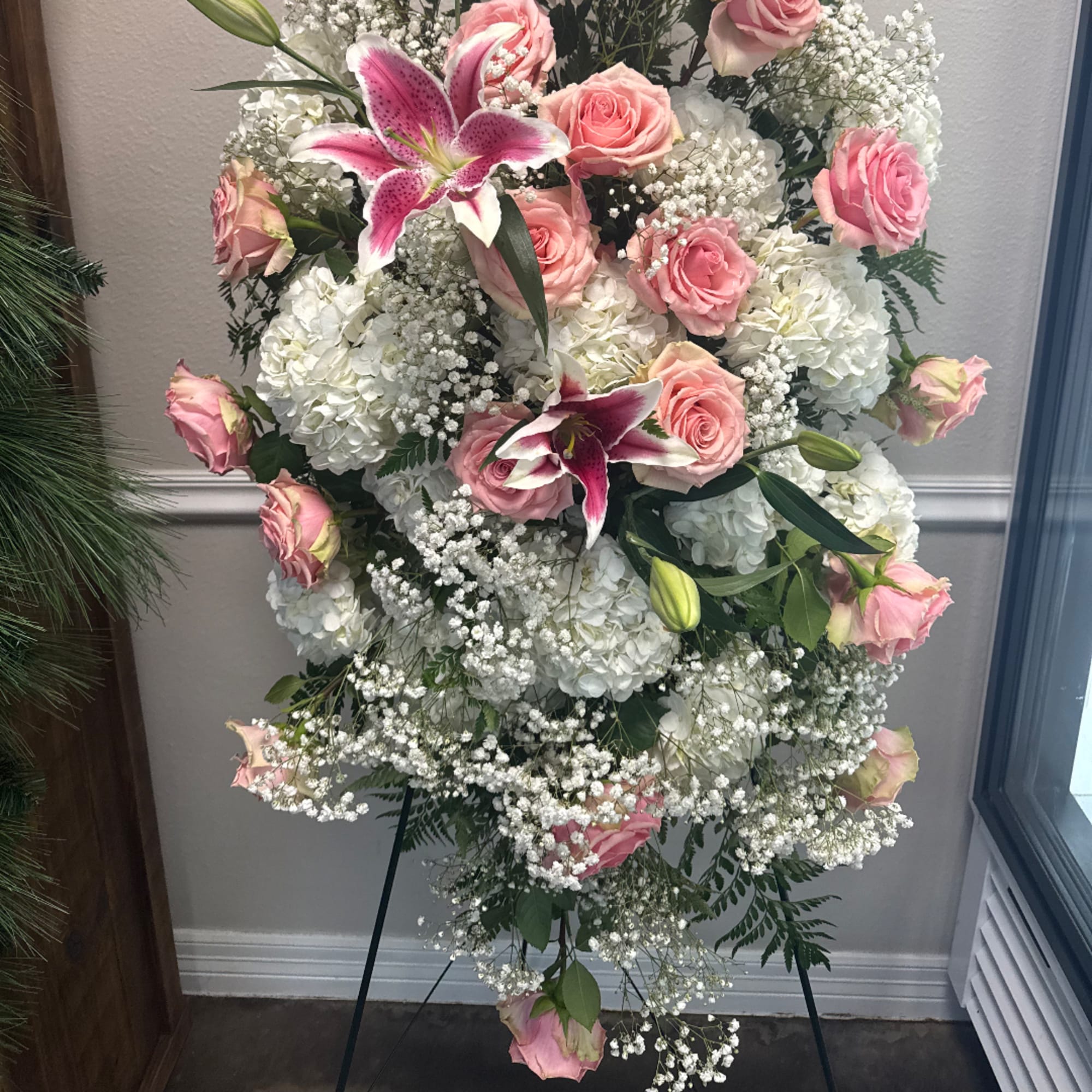 Standing floral spray with pink roses, white hydrangeas, and lilies