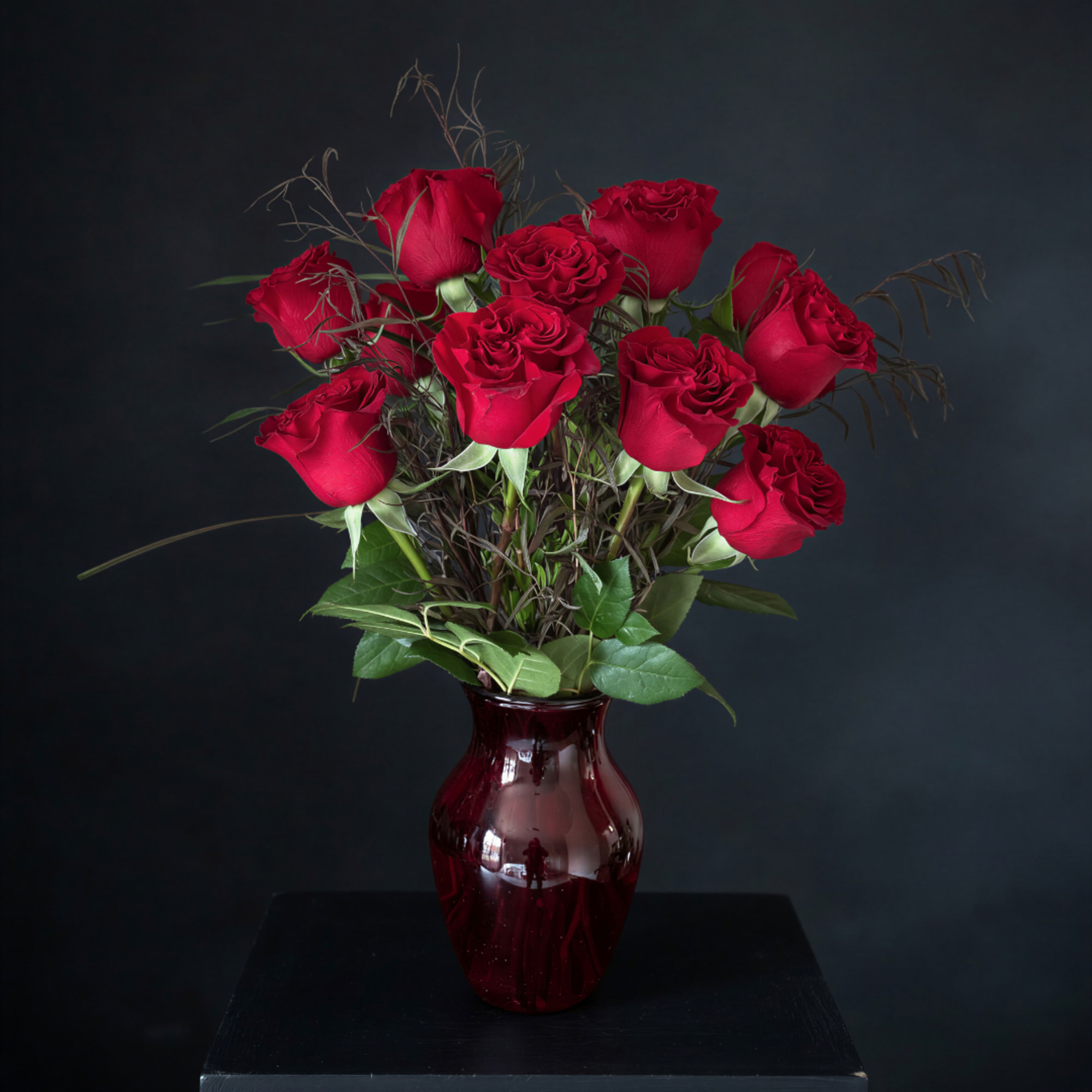 Red roses arranged in a burgundy glass vase, photo 4 of 4