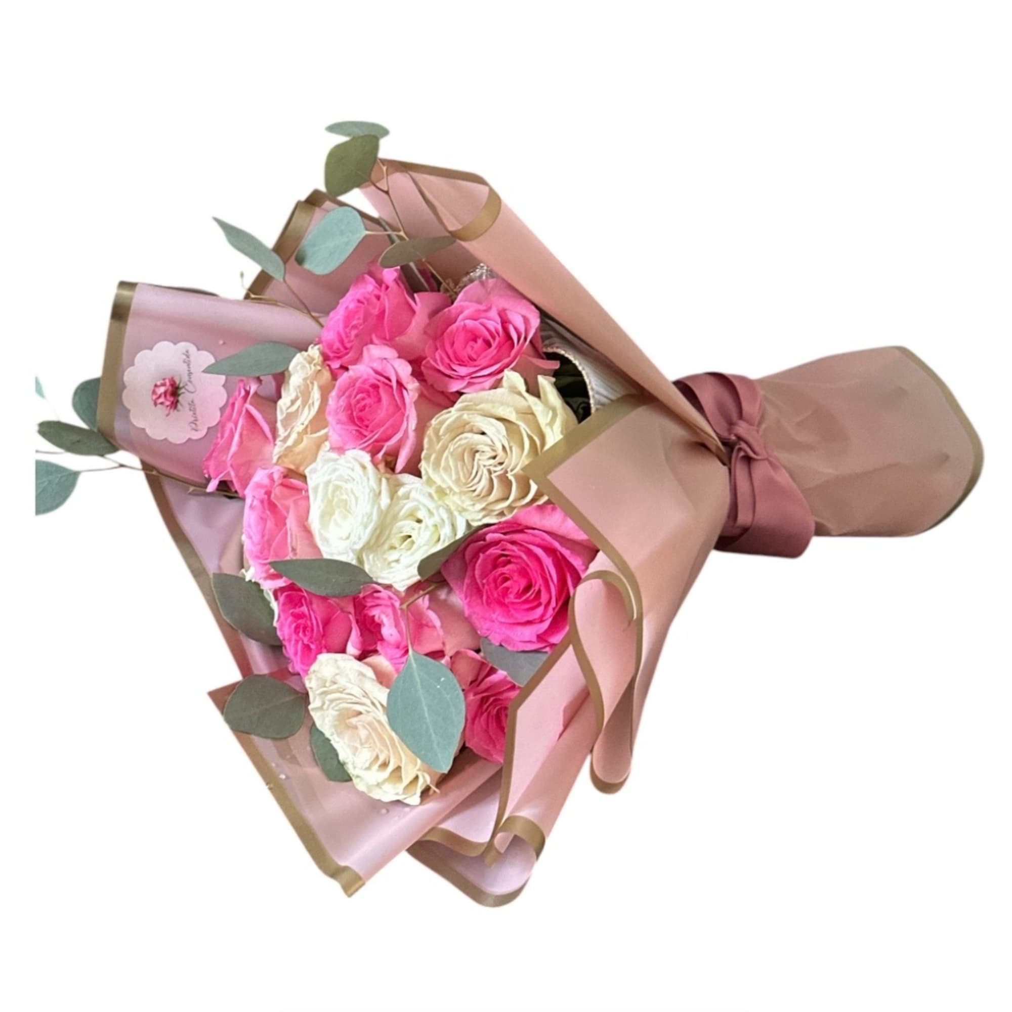 Bouquet of pink and cream roses wrapped in blush paper