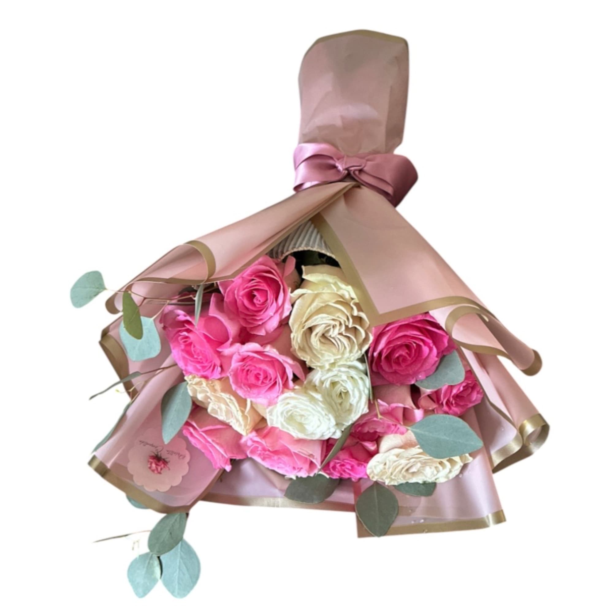 Bouquet of pink and cream roses wrapped in blush paper with a ribbon