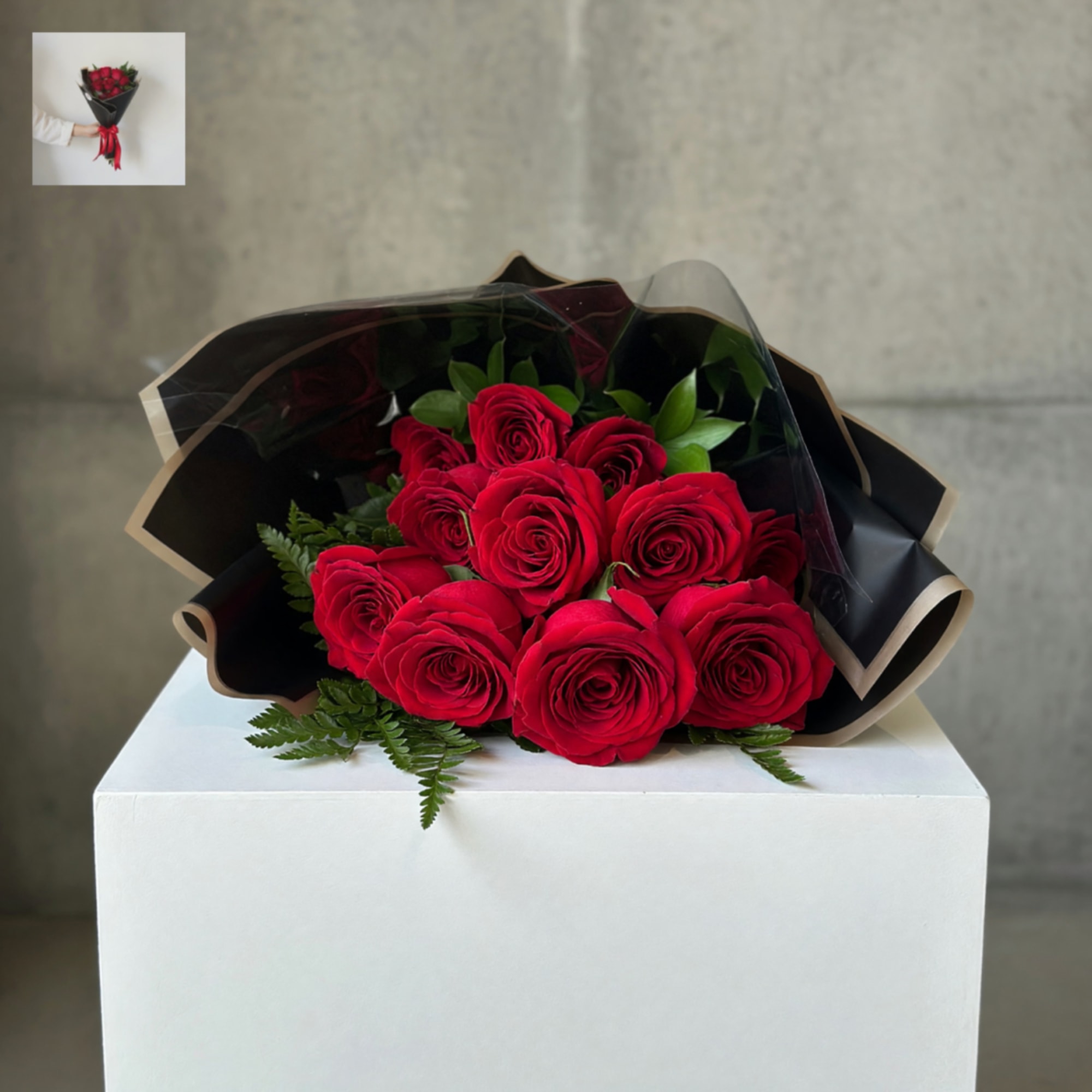 Bouquet of red roses wrapped in black paper with a red ribbon, photo 2 of 2