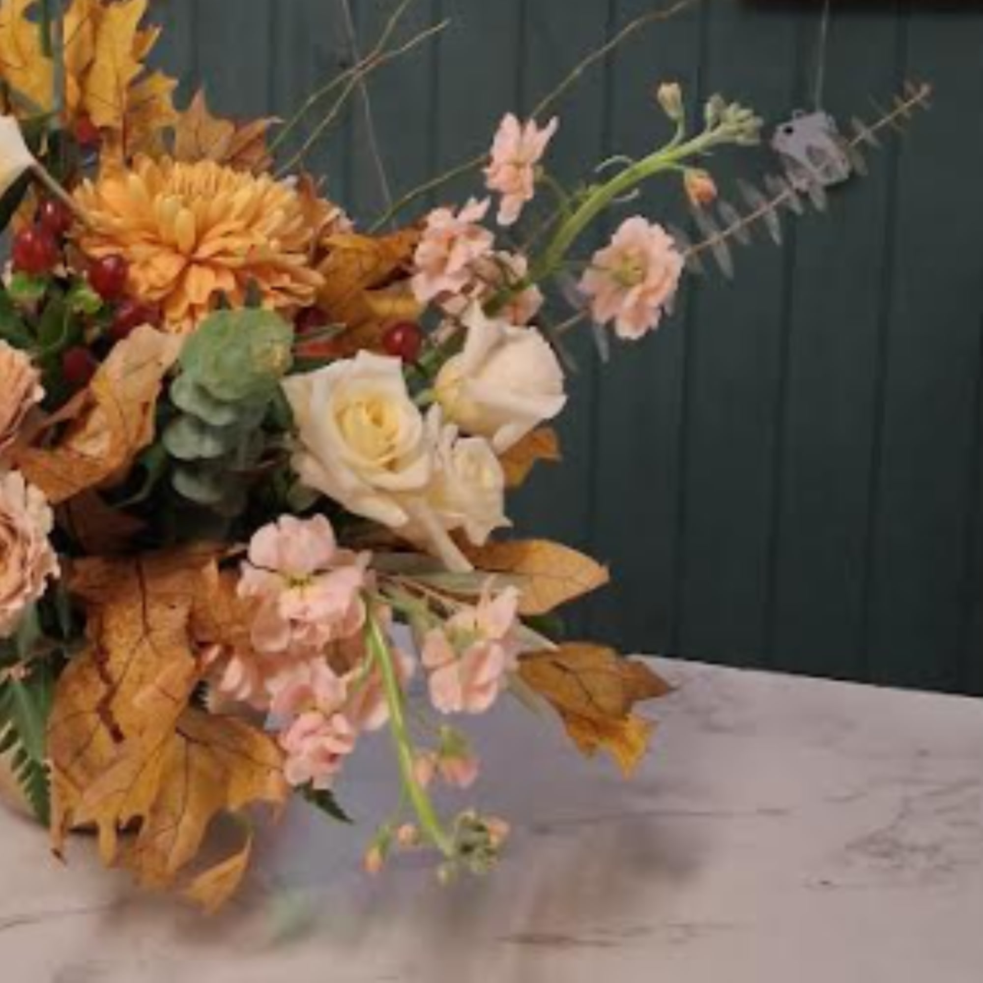 Autumn floral arrangement with cream roses and peach blooms