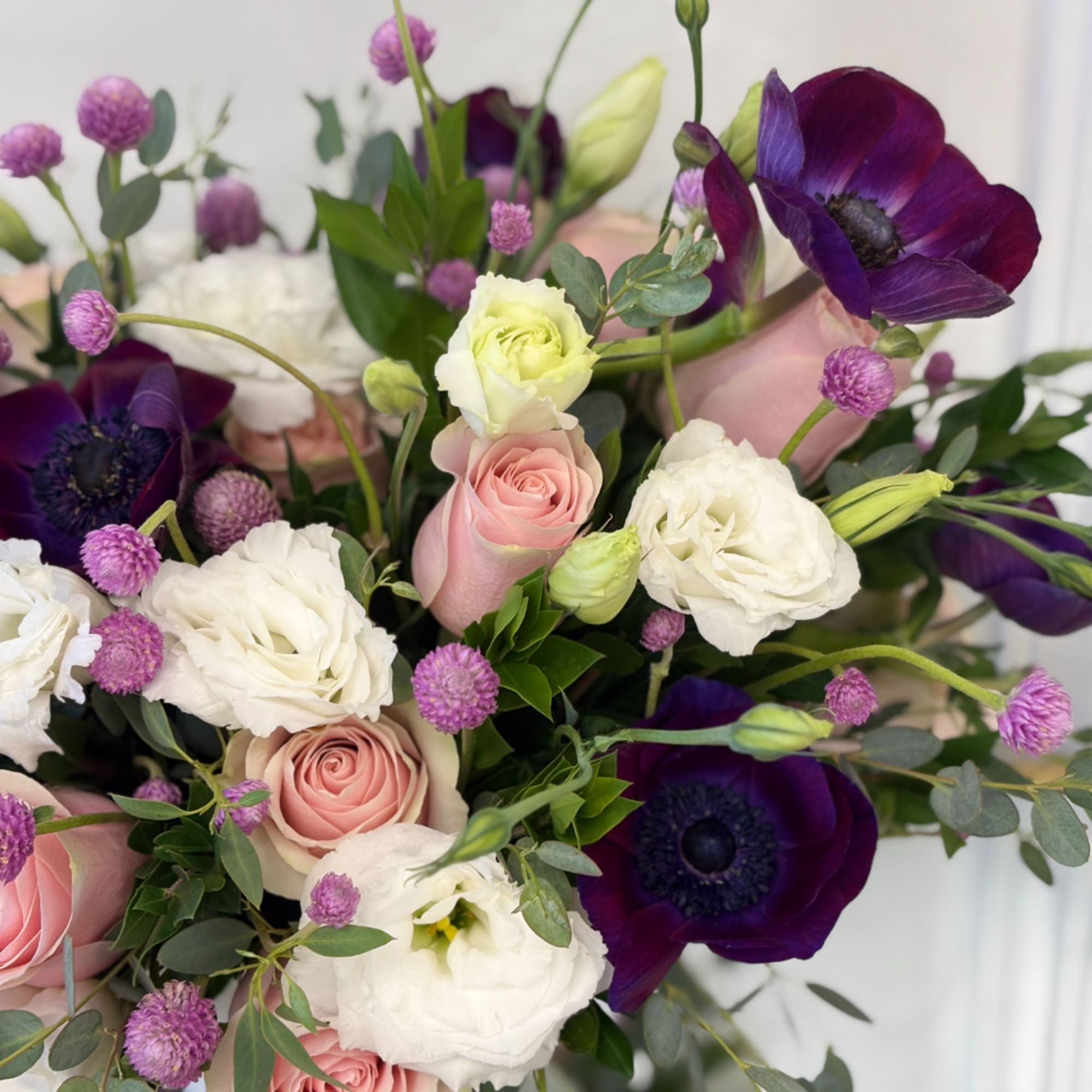 Bouquet of pink roses, white blooms, and deep purple flowers, photo 2 of 4