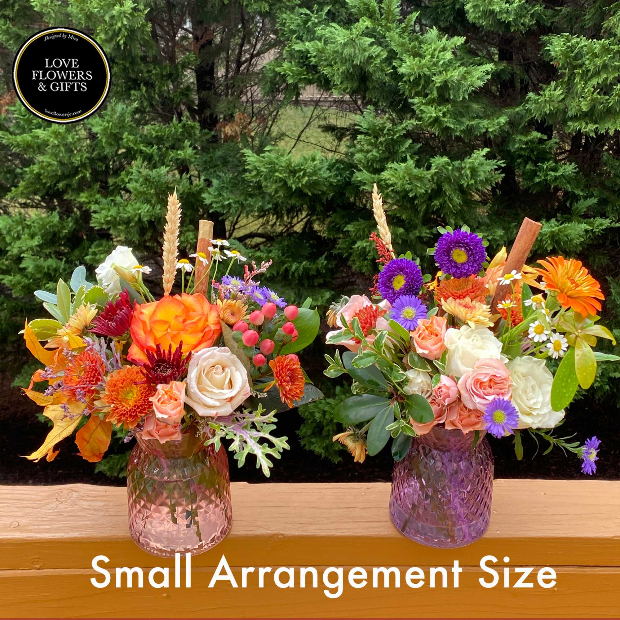 Two small mixed flower arrangements with roses, mums, and asters in pink glass vases.