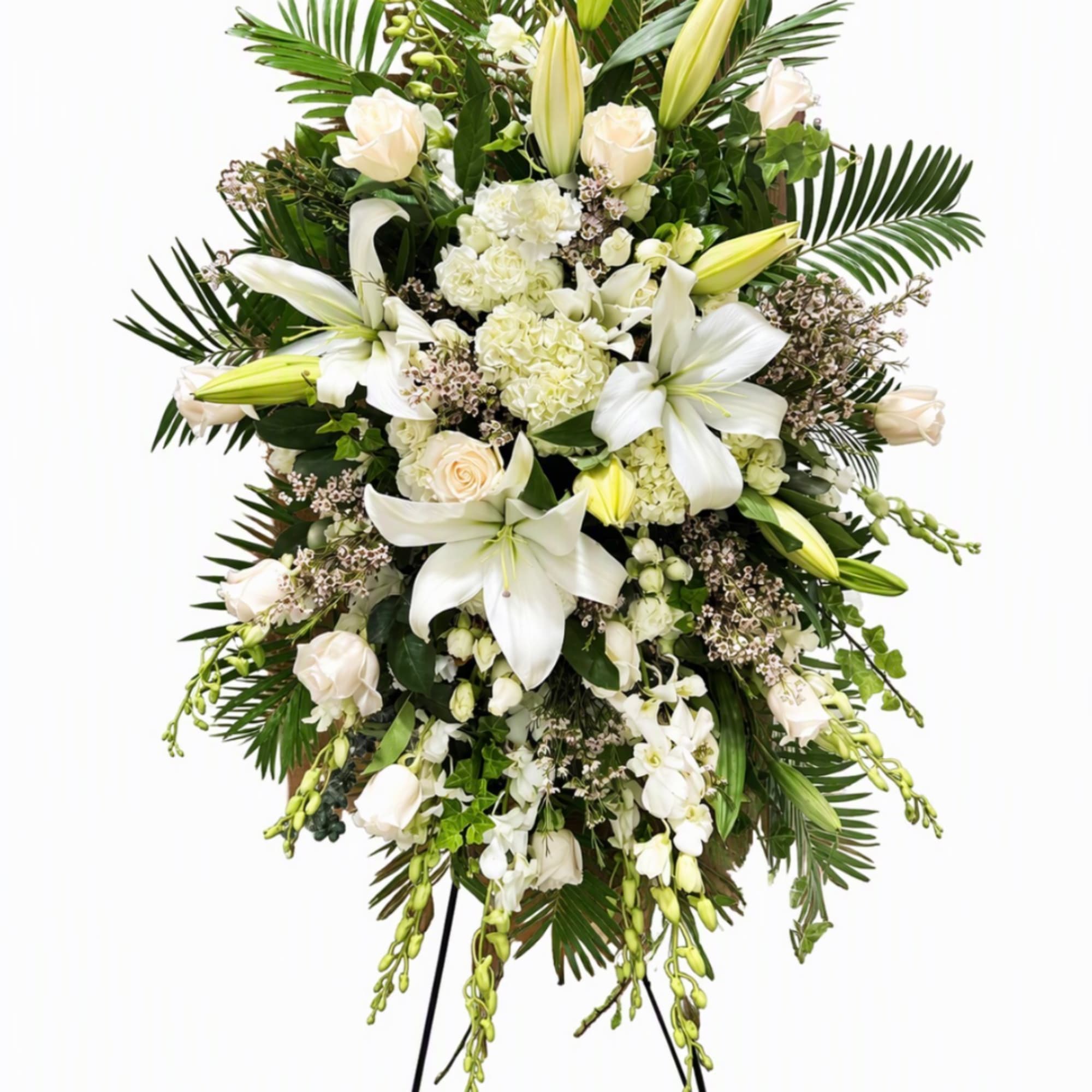 White floral standing spray with lilies, roses, and orchids on a stand