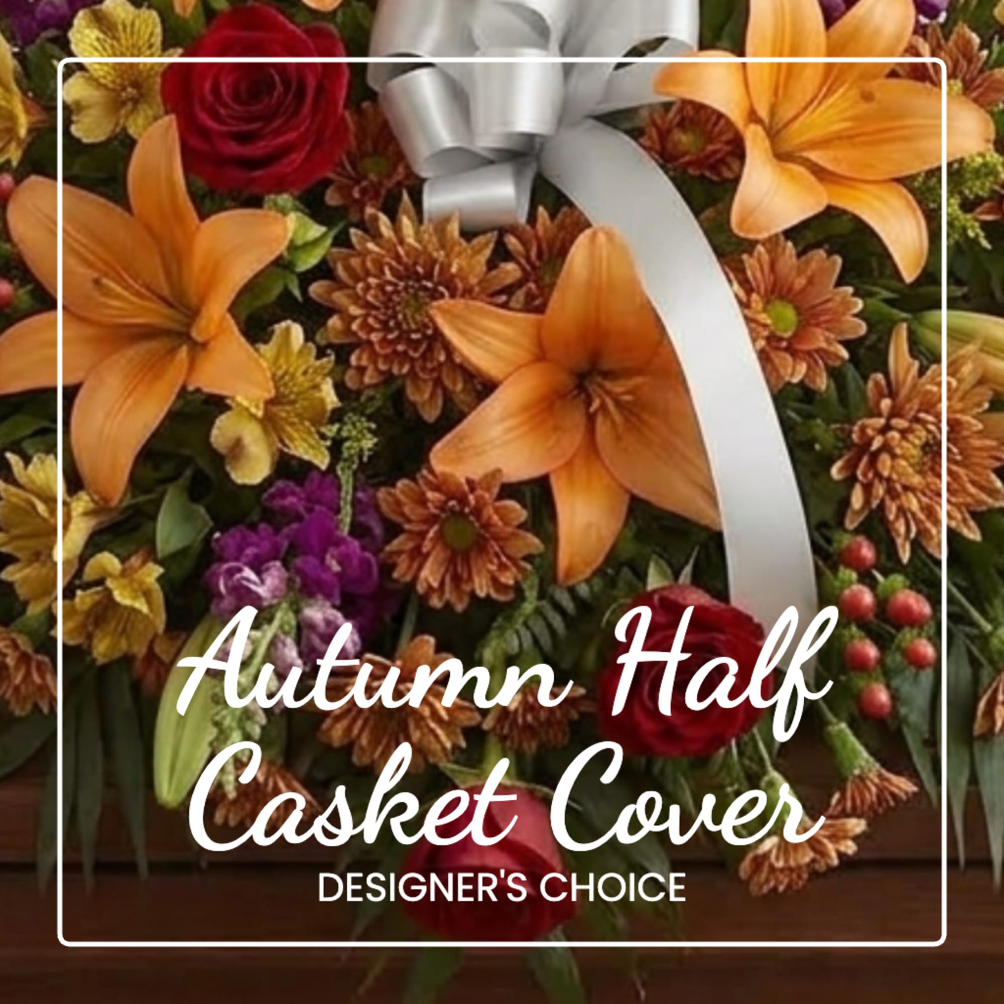 Autumn floral casket cover with orange lilies, red roses, and a silver bow