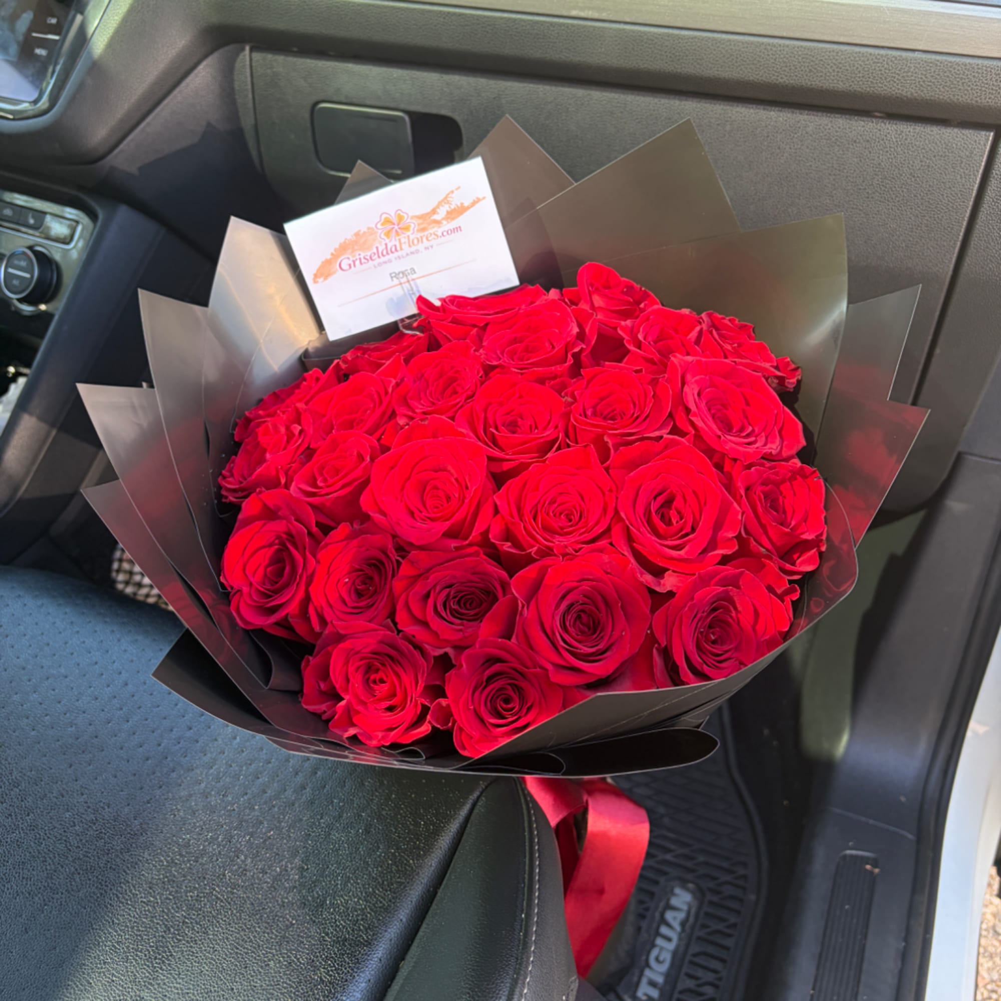 Bouquet of red roses wrapped in black paper with a red ribbon, photo 2 of 4