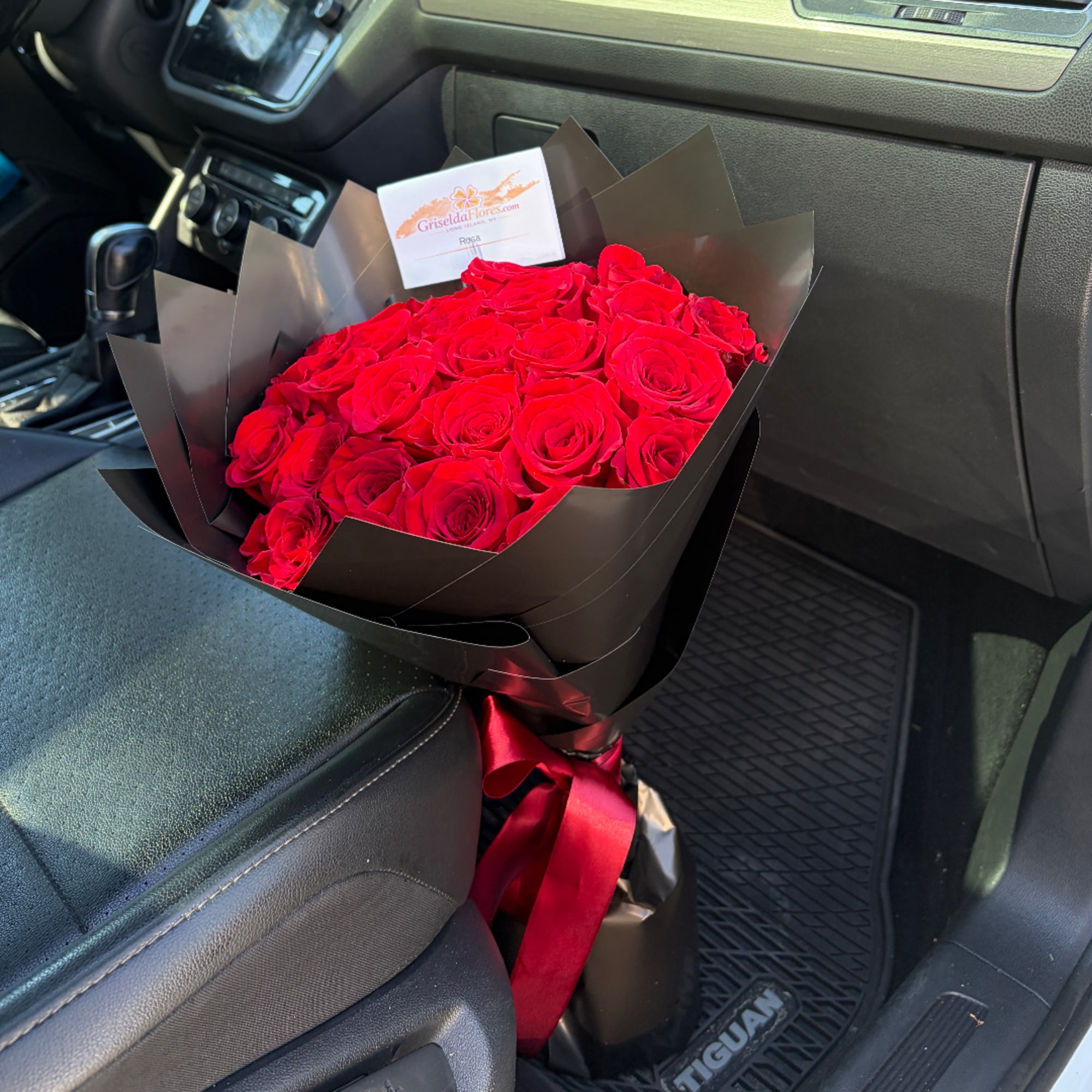 Bouquet of red roses wrapped in black paper with a red ribbon, photo 3 of 4