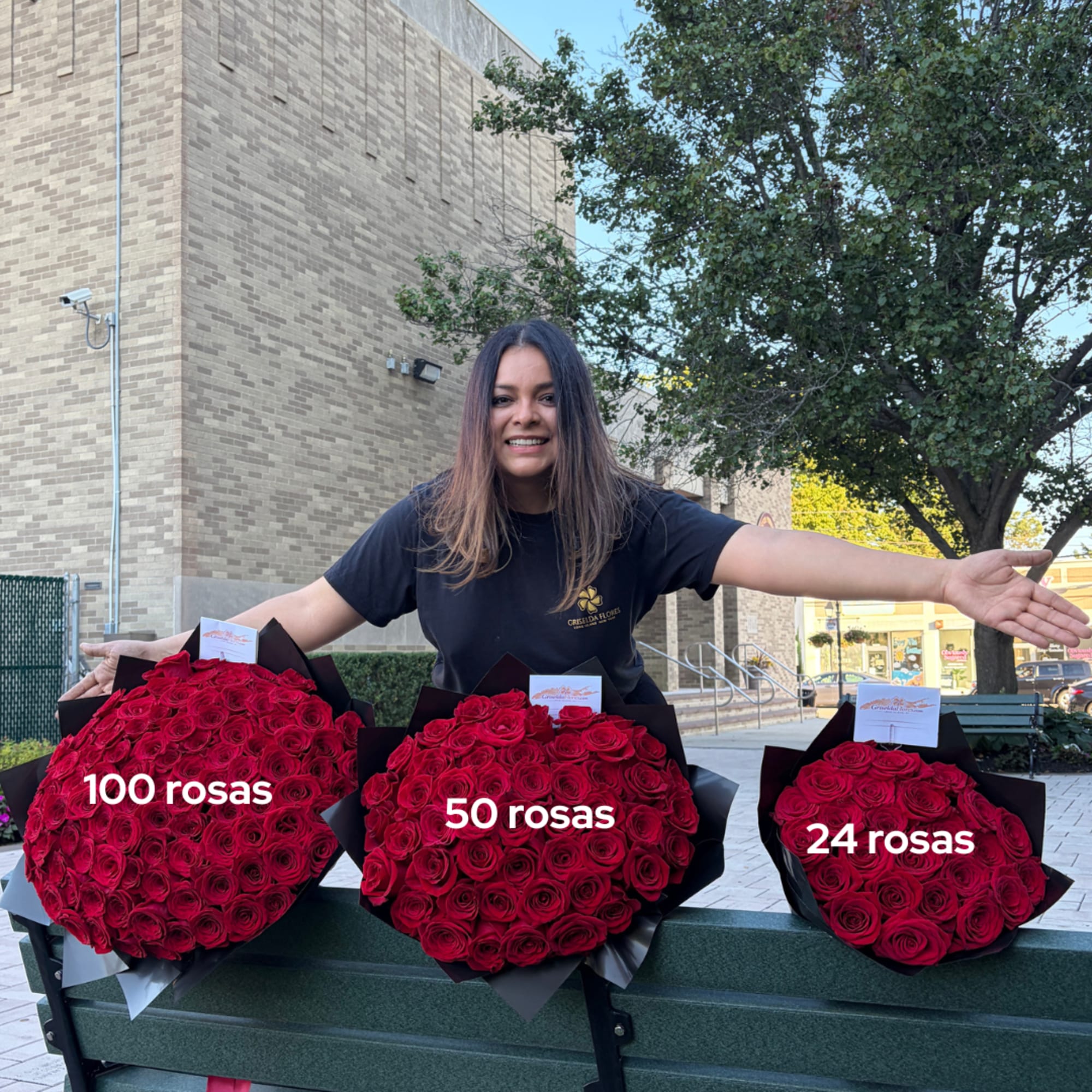 Woman standing behind three large red rose bouquets