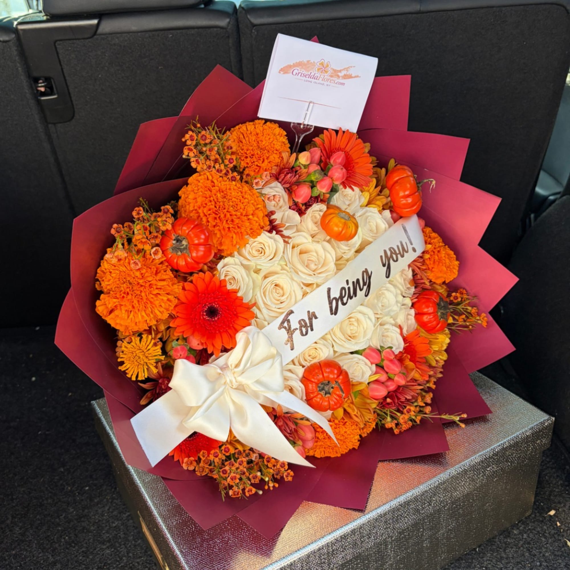 Orange and cream bouquet with roses, gerberas, and small pumpkins