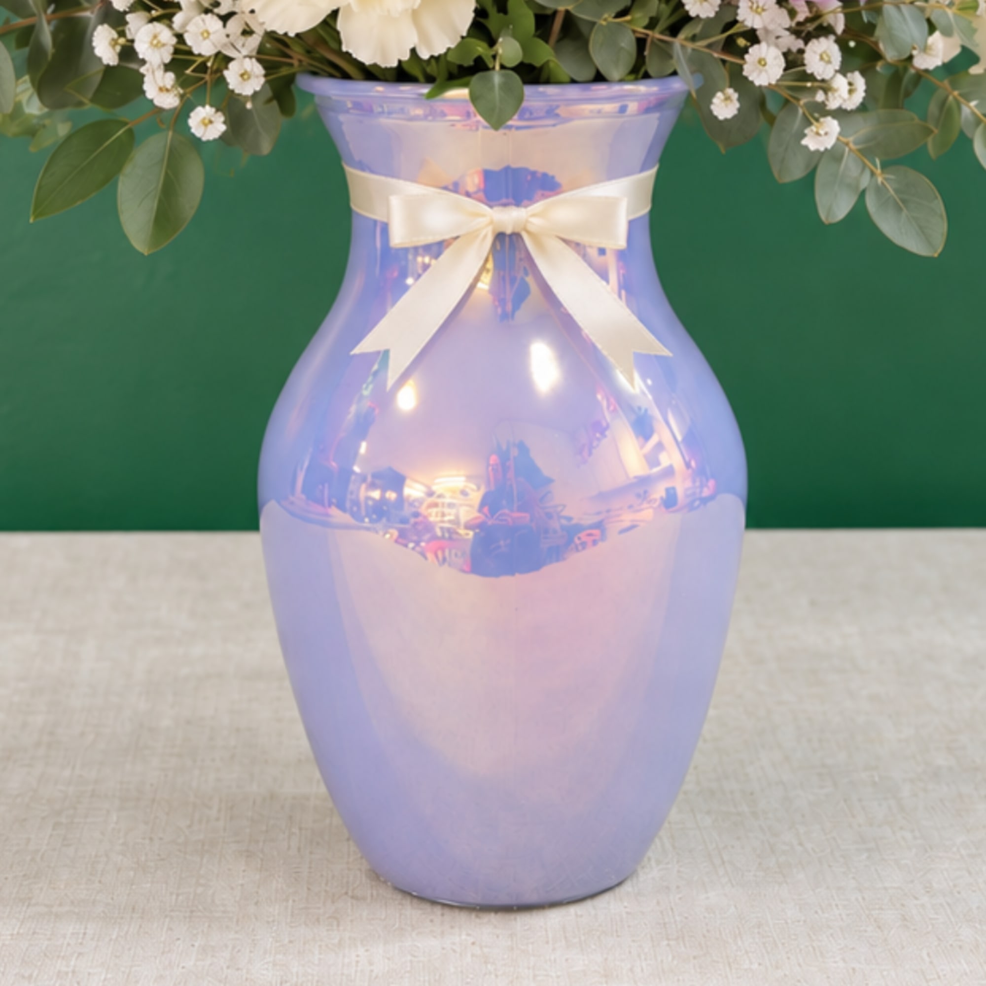 Lavender vase with a cream ribbon and white flowers at the top