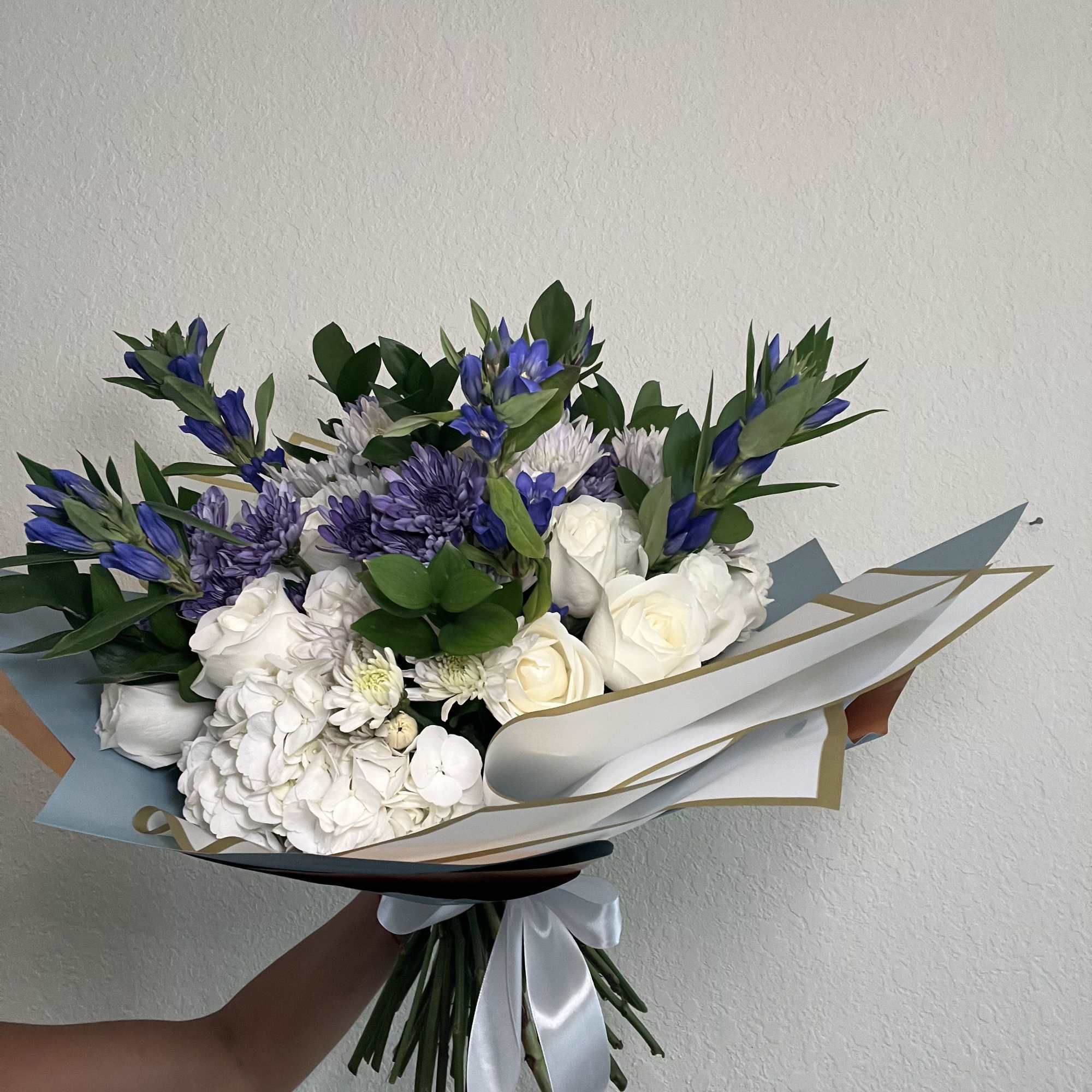 Bouquet of white and purple flowers wrapped in pastel paper, photo 2 of 2