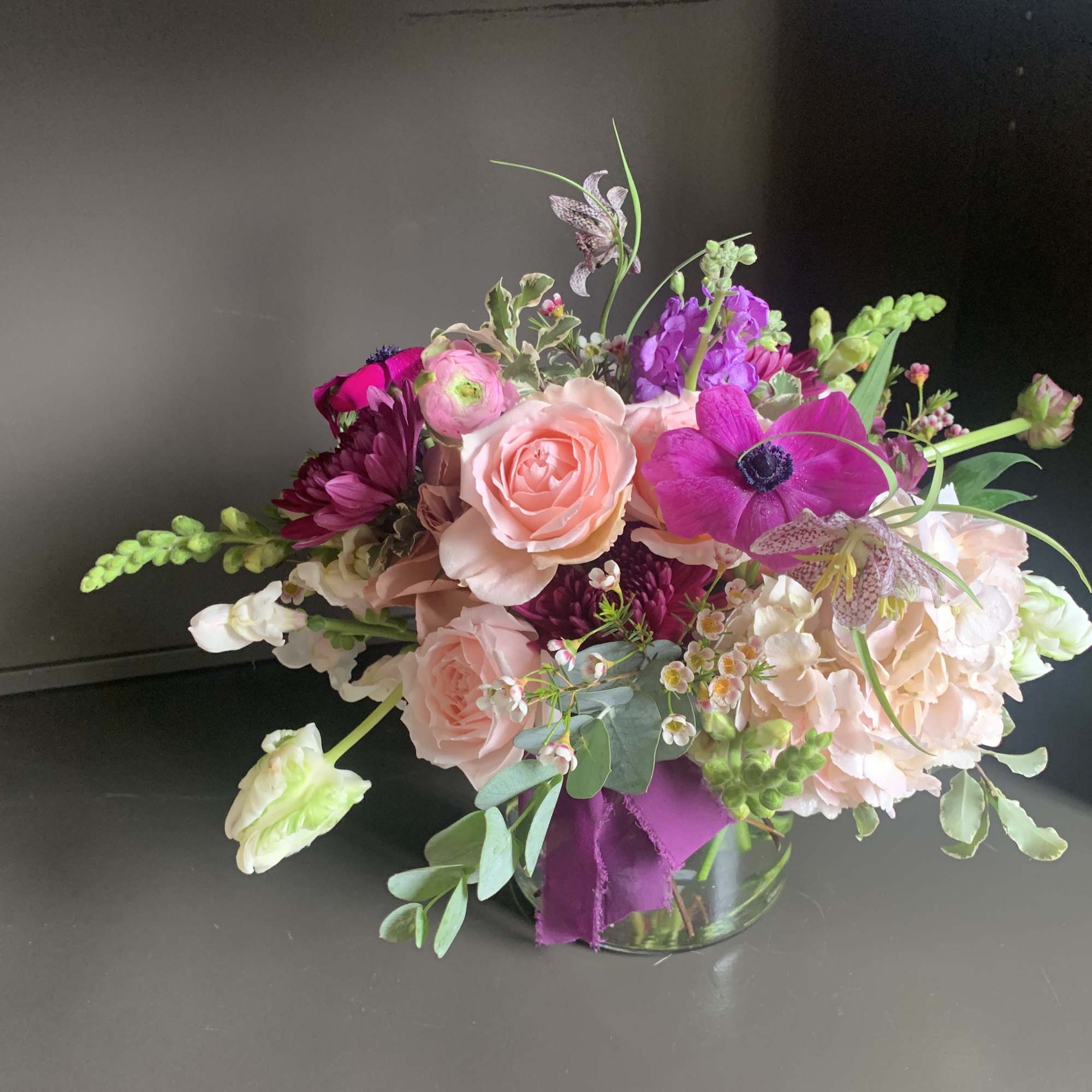 Pink and purple mixed bouquet in a glass vase