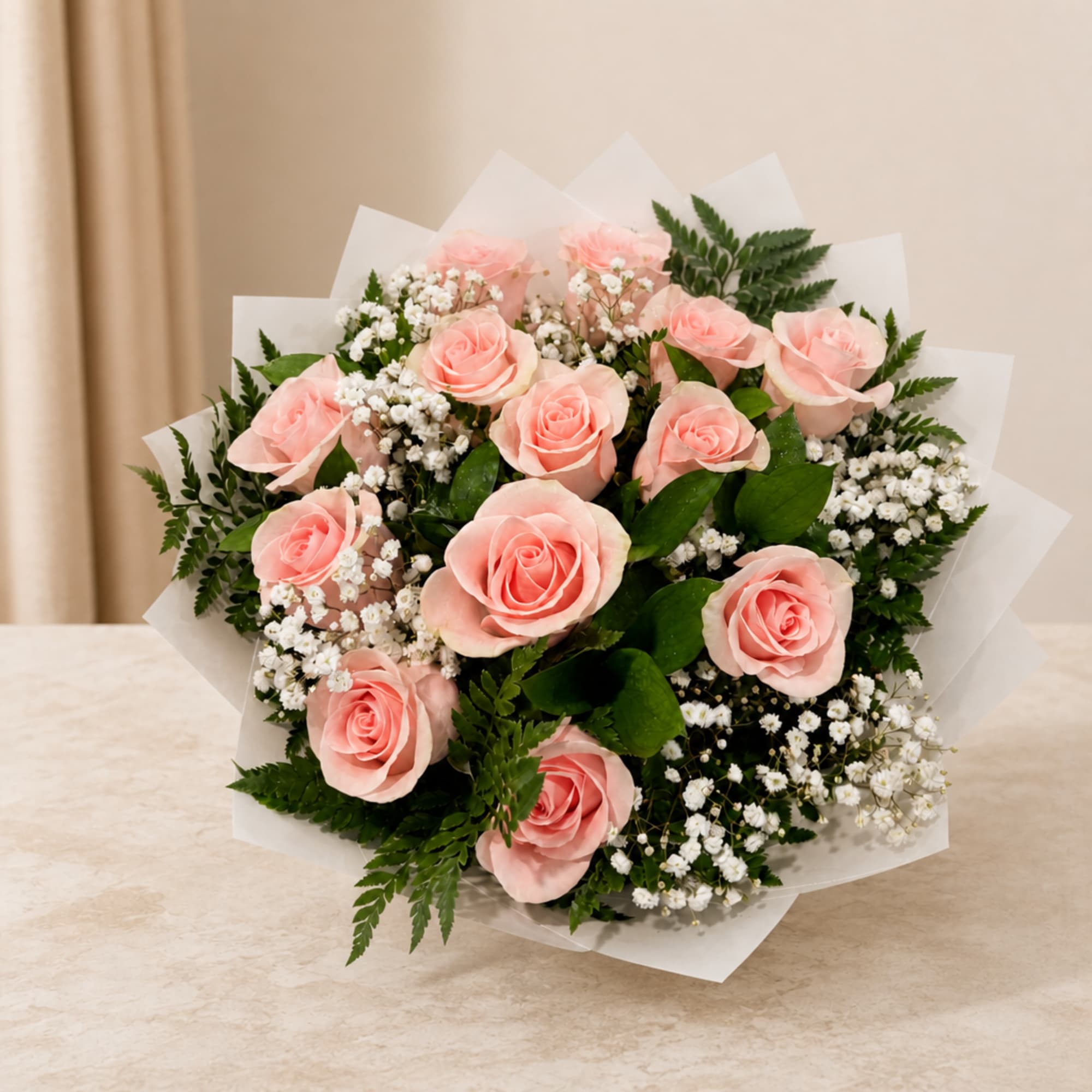 Bouquet of pale pink roses with white filler flowers and greenery
