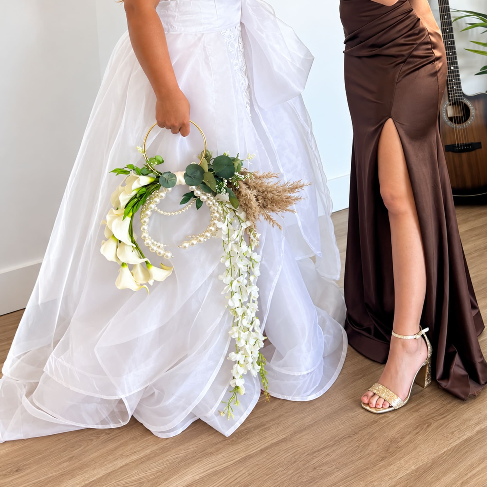 Bride holding a floral hoop bouquet with white flowers and pearl accents