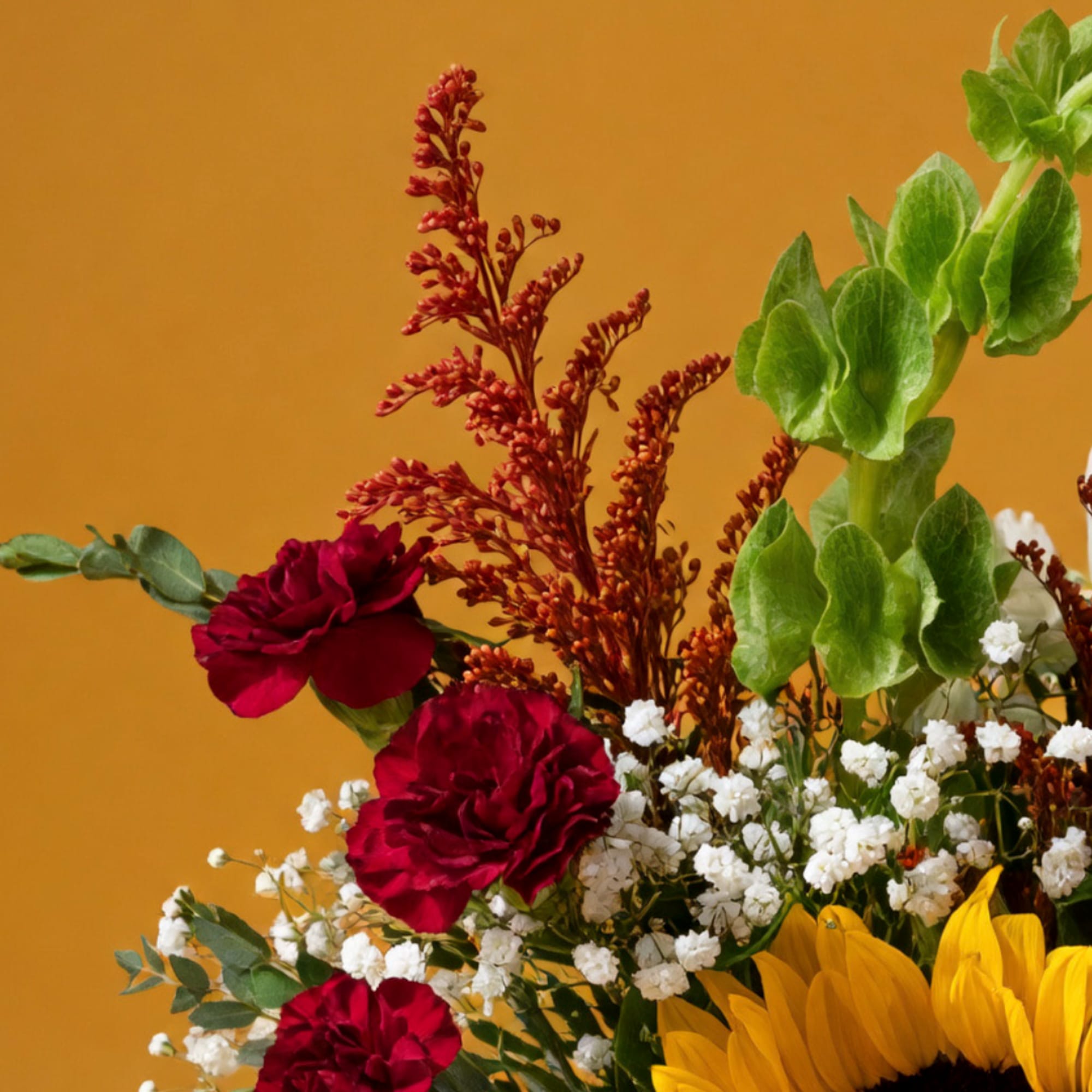 Bouquet with red carnations, yellow sunflowers, and white baby's breath