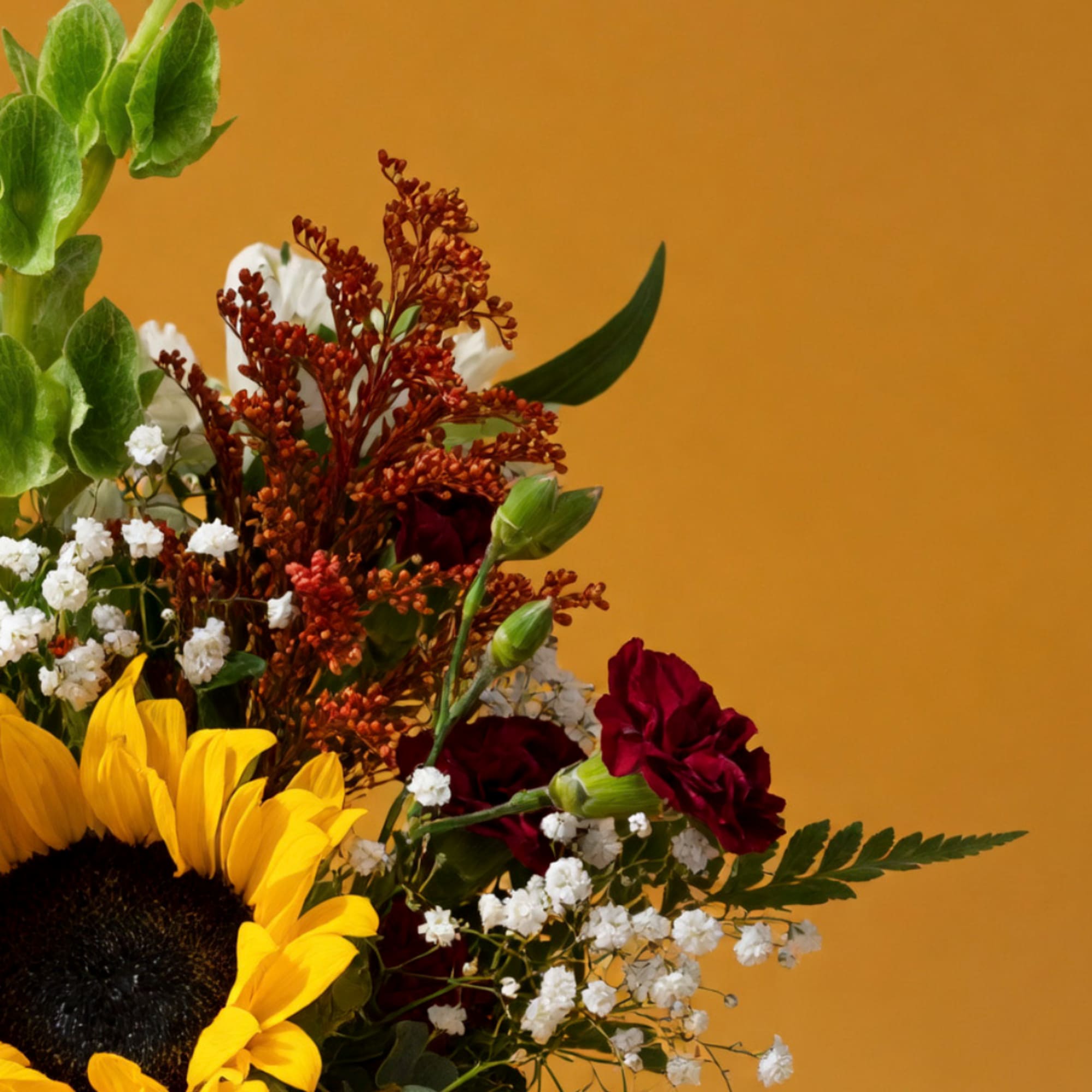 Sunflower bouquet with red carnations and white filler flowers