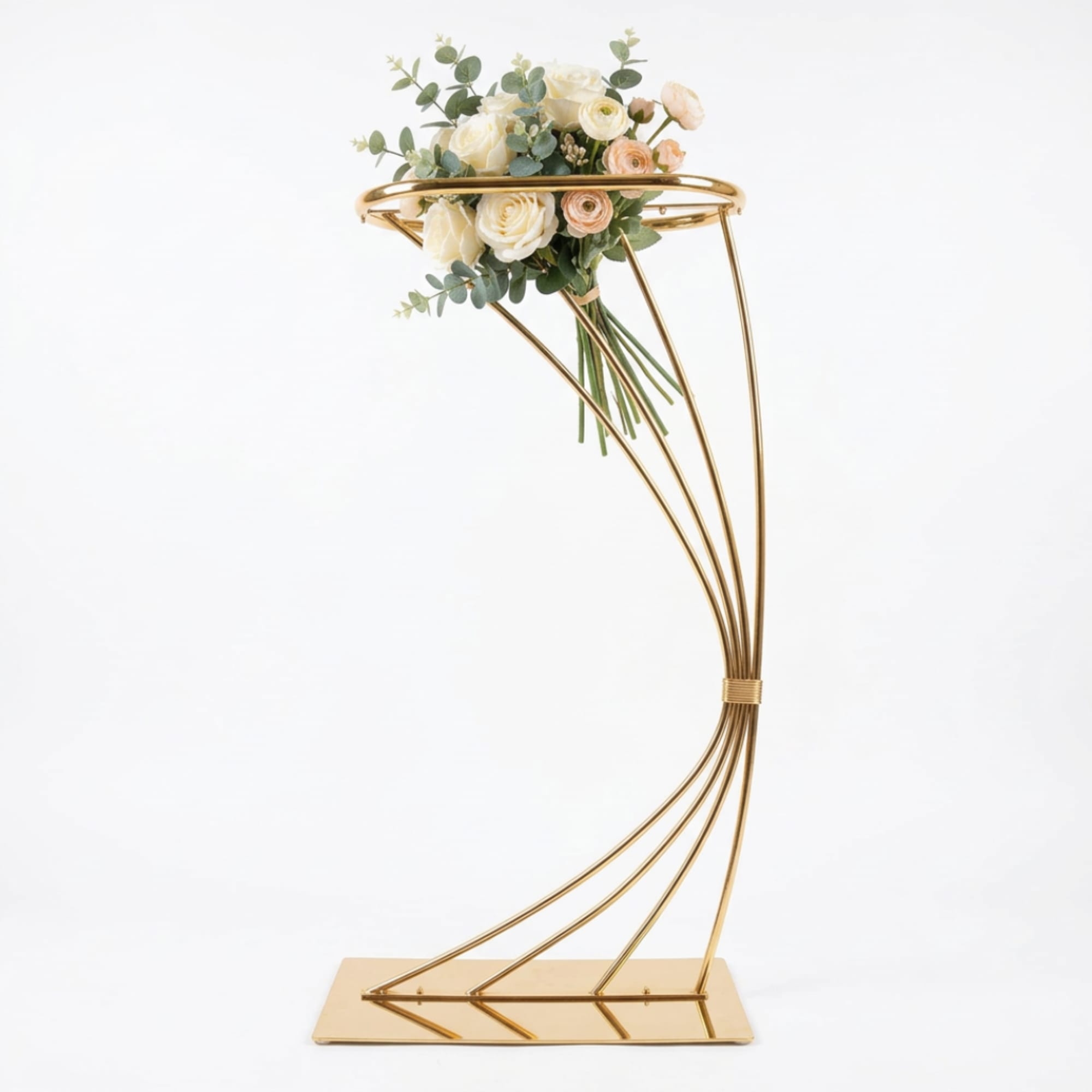 Cream roses and peach ranunculus in a gold stand arrangement