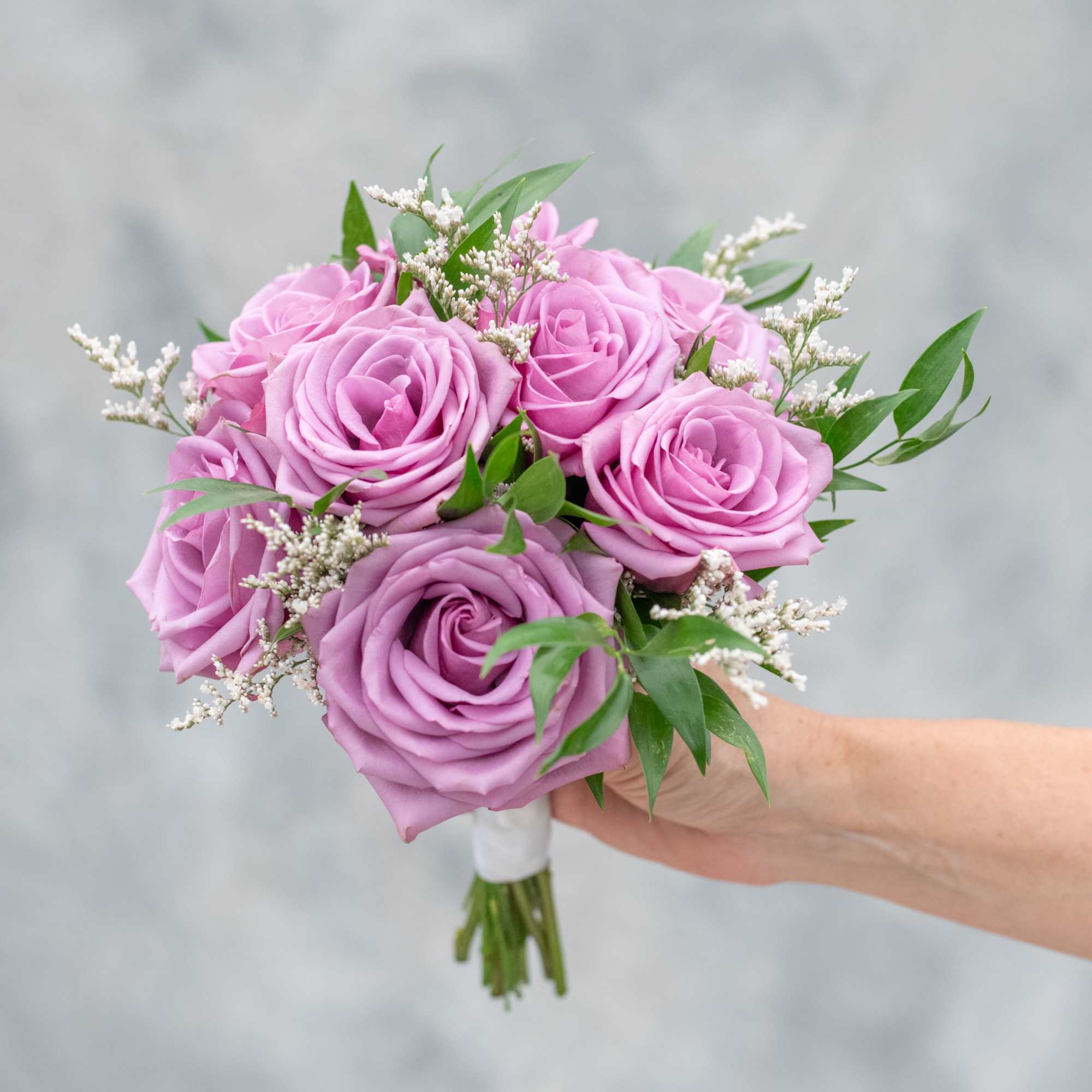 Eight roses with just a hint of greenery. You choose the color
