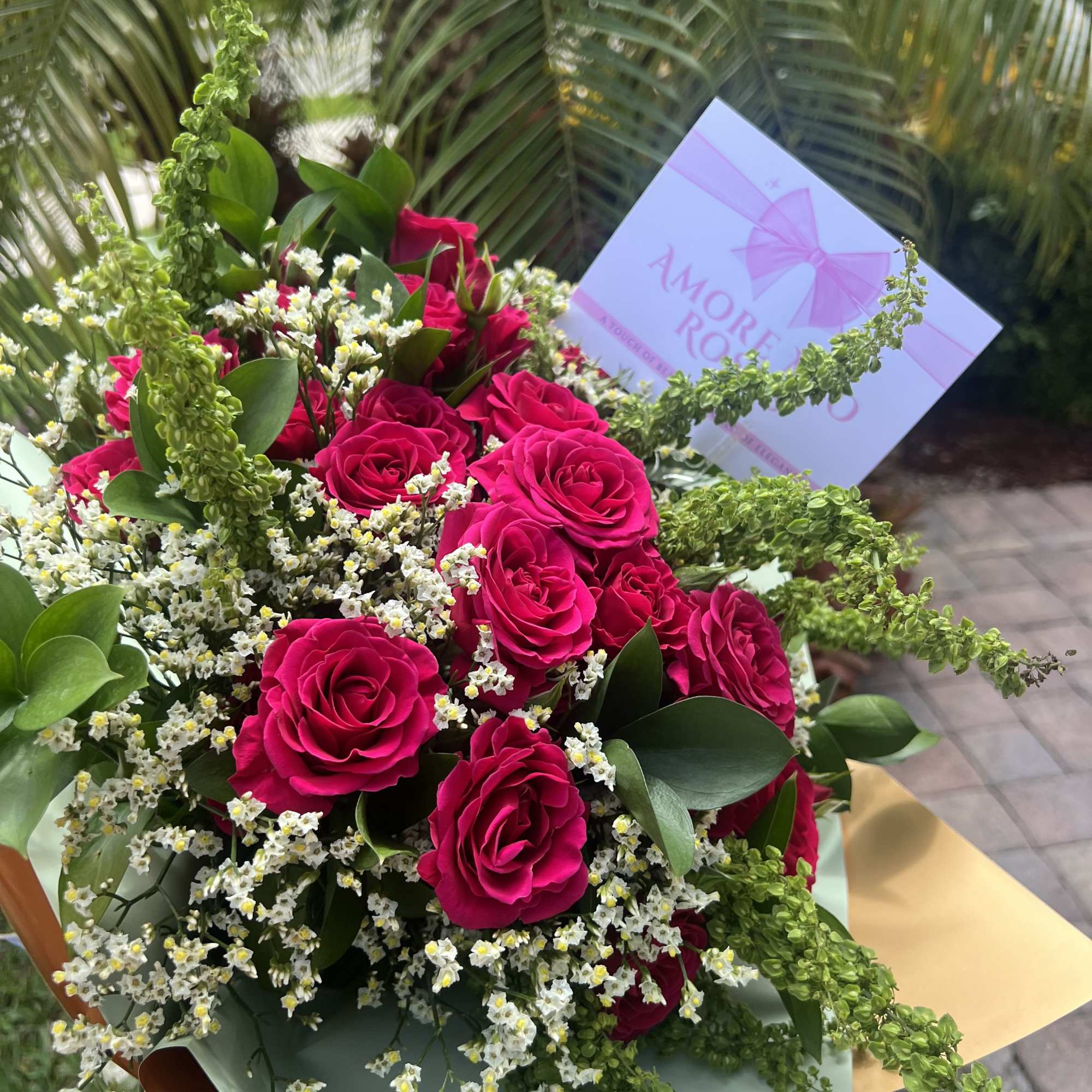 Bouquet of hot pink roses with white filler flowers and greenery, photo 2 of 2