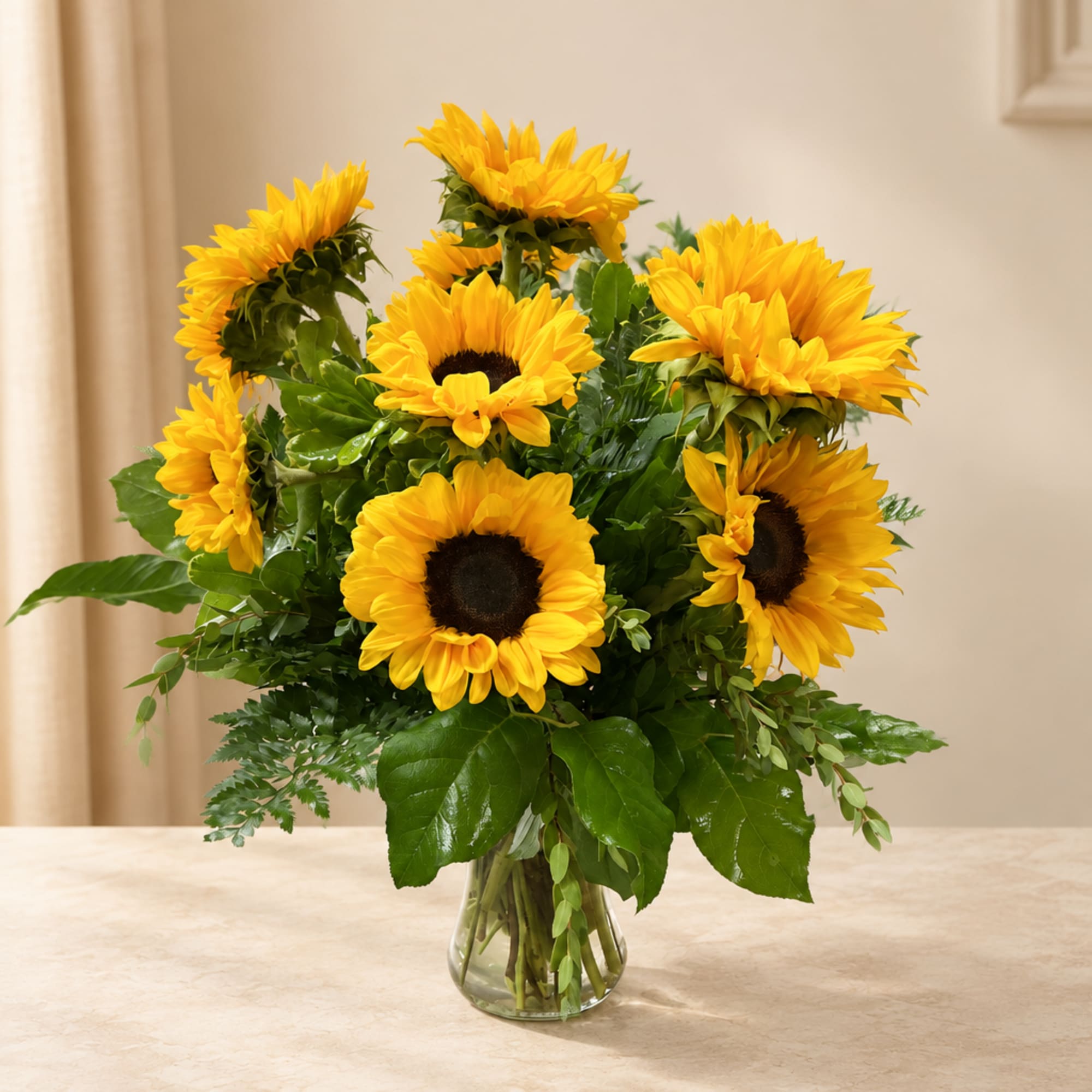 Bouquet of yellow sunflowers in a clear glass vase
