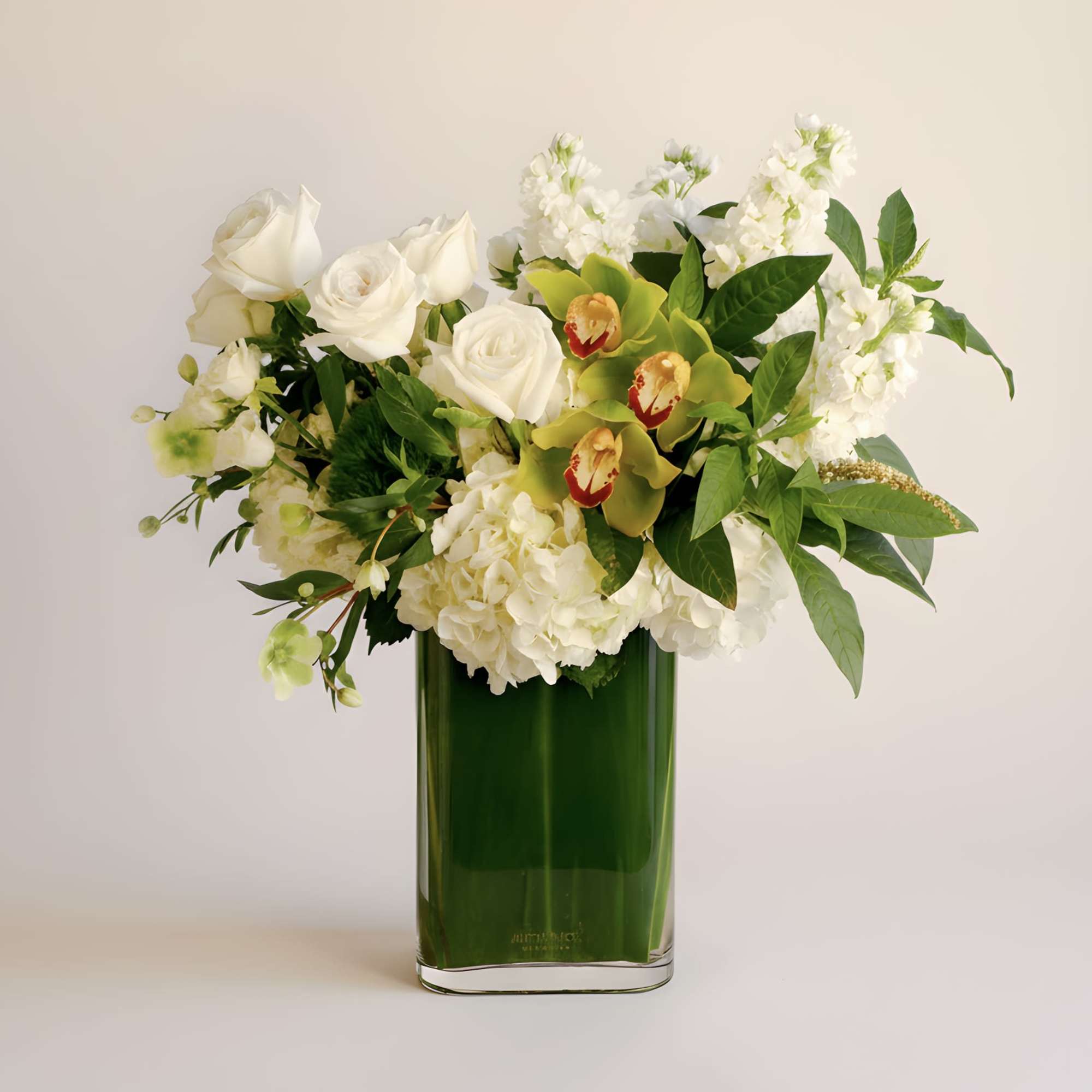 This modern arrangement features an elegant collection of green cymbidium orchids, white