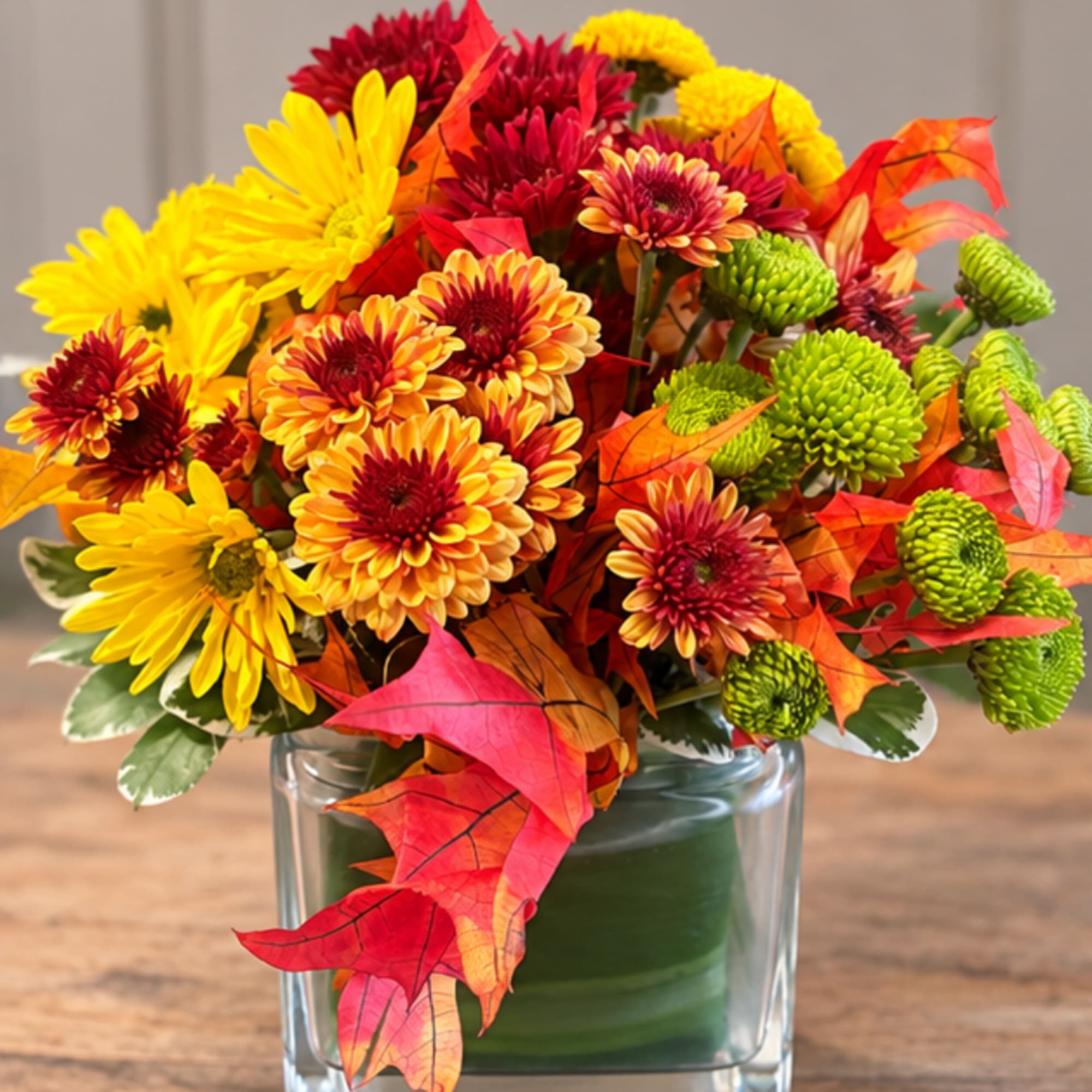 Autumn bouquet of yellow and red chrysanthemums in a glass vase