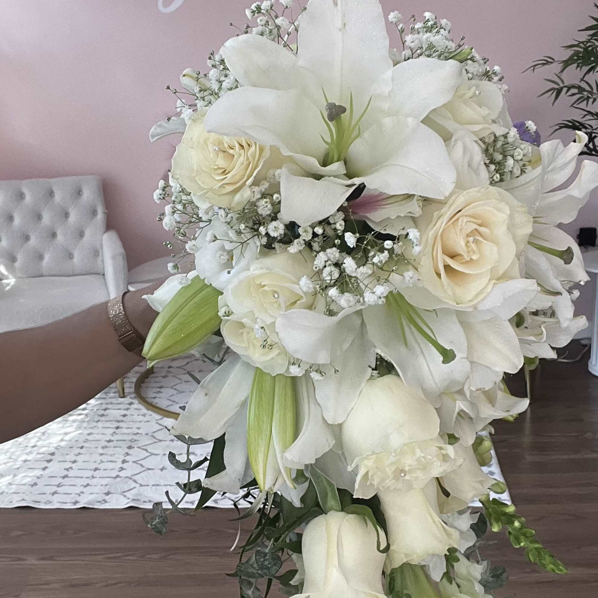 Large white bouquet with lilies and roses, held in hand