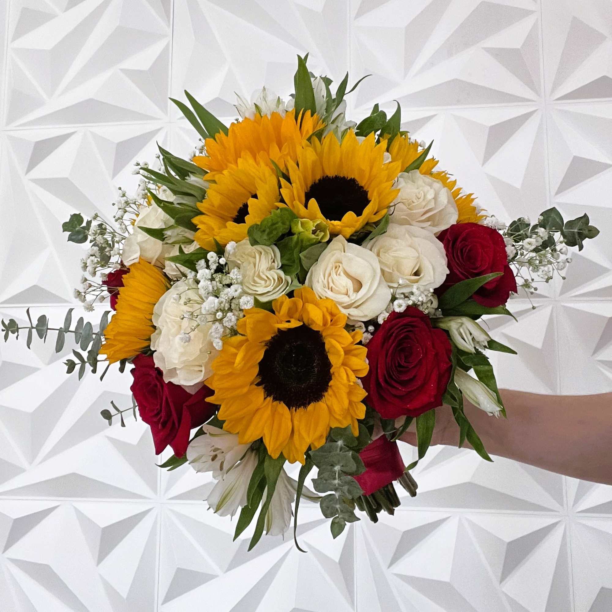 Bouquet of sunflowers, red and white roses, and white filler flowers